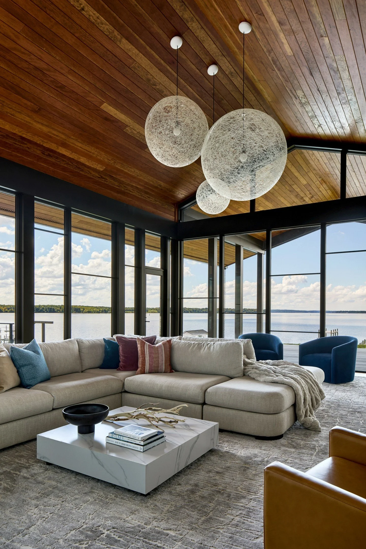 This great room had two focal points: the water views and the vertical glass fireplace.  So we commissioned a custom sectional with seating that allowed enjoyment of both equally - plus allowed this young family to gather and enjoy the amazing space 