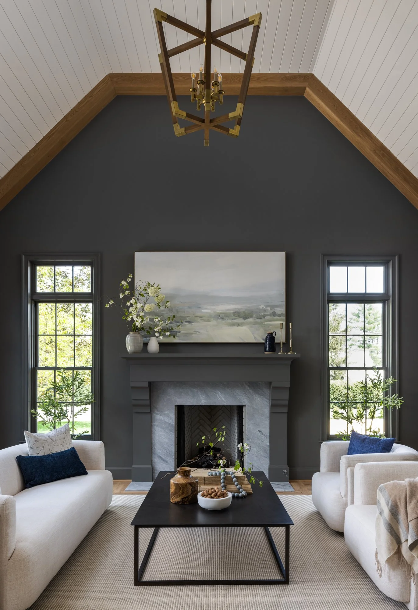 Statement wall and fireplace sitting room in modern classic estate by Wellhouse & Co.