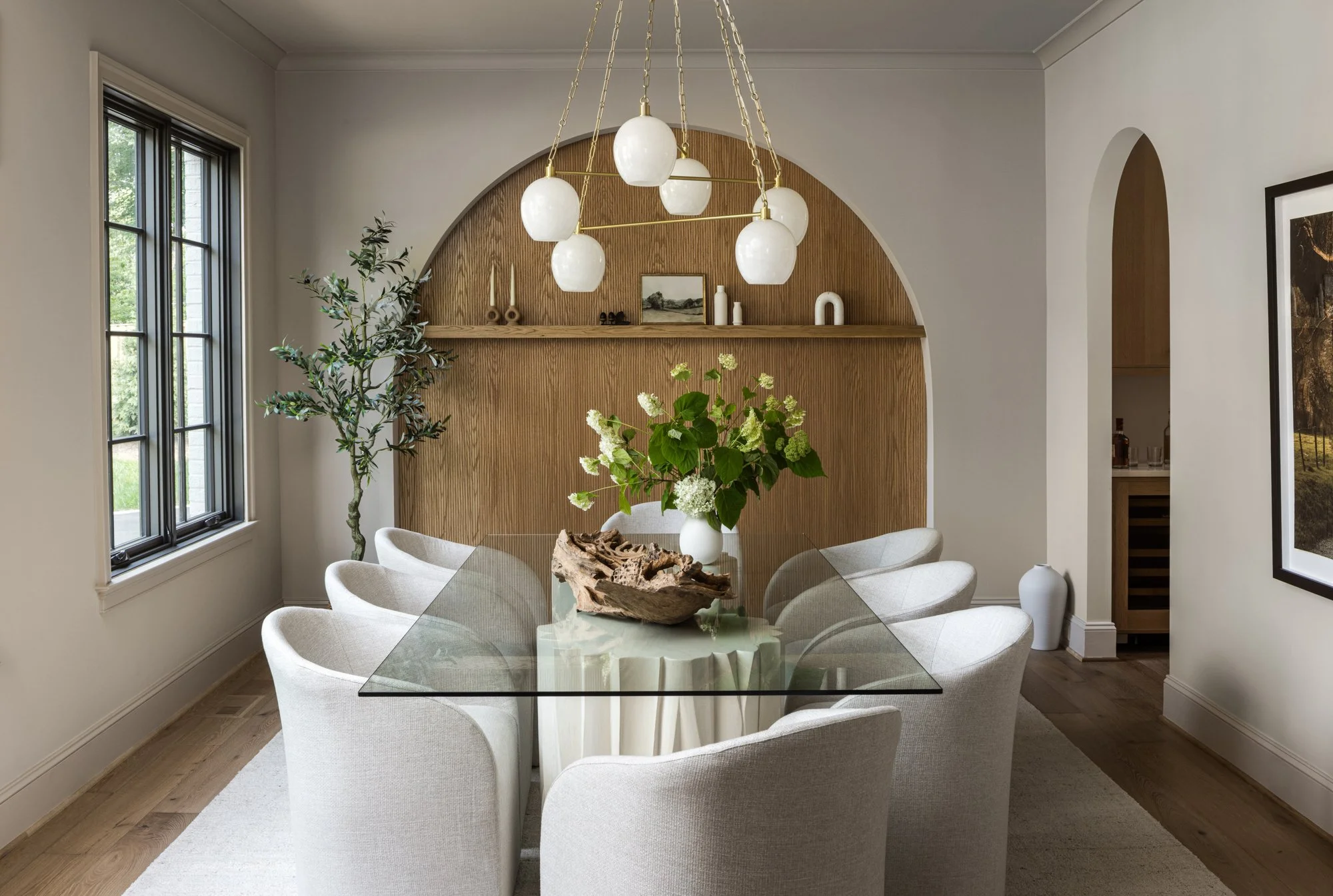 Dining room with statement light fixture in tailored traditional home by Wellhouse & Co.