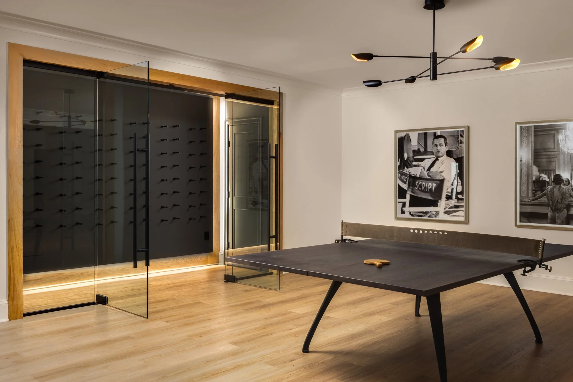 Game room activity space in modern classic estate home by Wellhouse & Co.