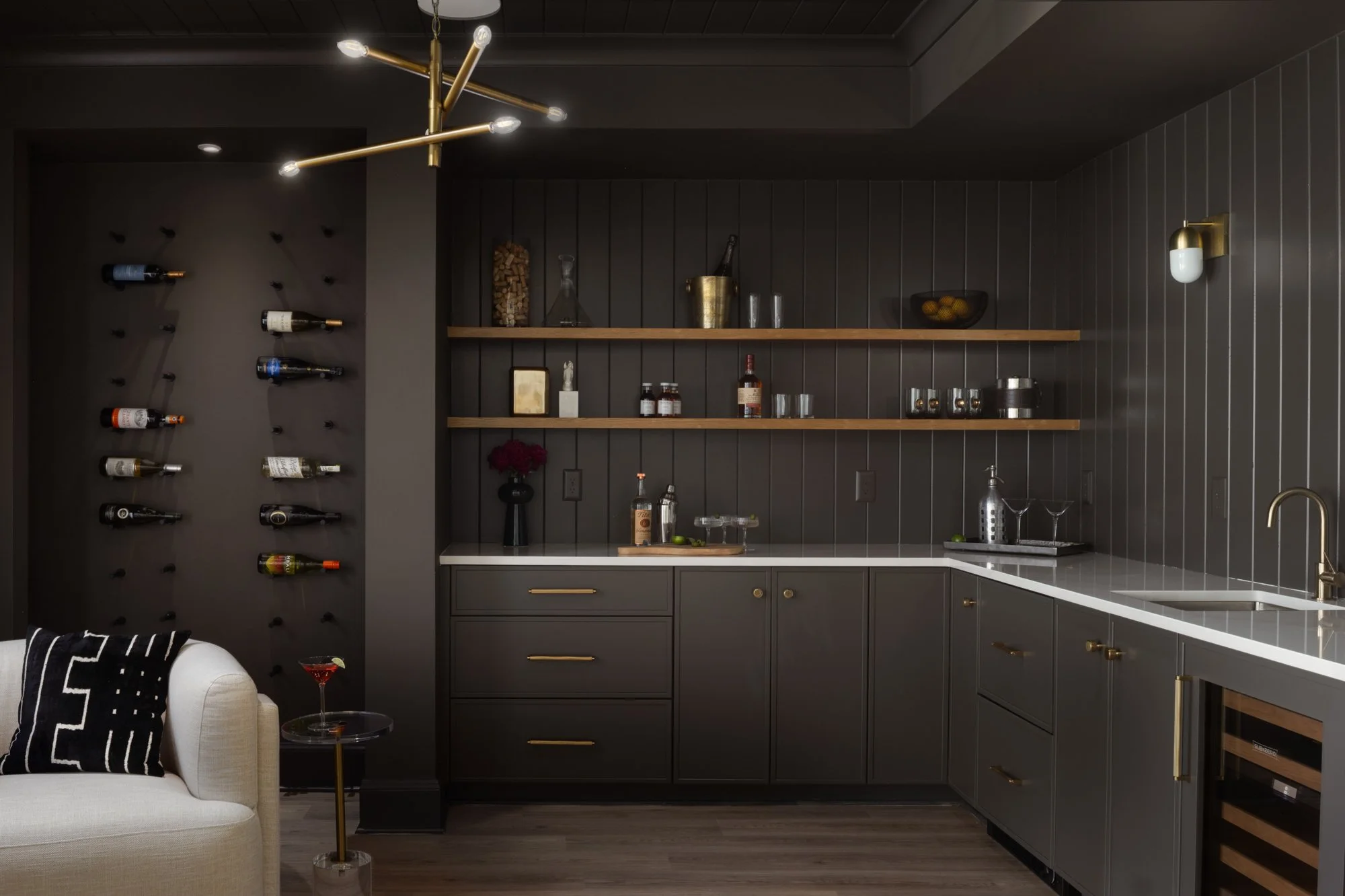 Moody home bar with bold cabinetry in tailored traditional home by Wellhouse & Co.