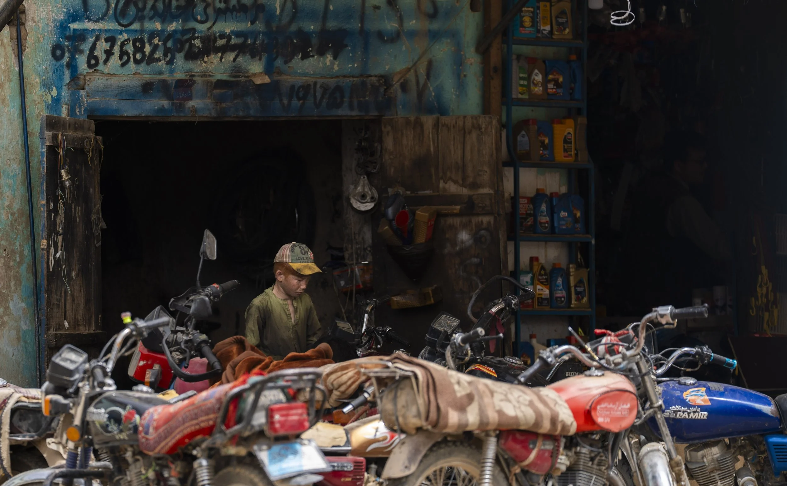 Kunduz, somewhere between Badakhshan and Kabul.
A quick stop. A small town, windy and dusty.
I saw him on a street corner. Silent, concentrated, his hands full of adult work.
He wasn’t old enough, but he already had the role.
Here, many children gro