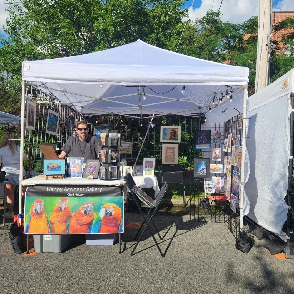 Happy Accident Gallery booth at an outdoor art festival
