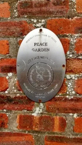 Peace plaque placed in the garden in 1986 when it was designated a Peace Garden.jpg