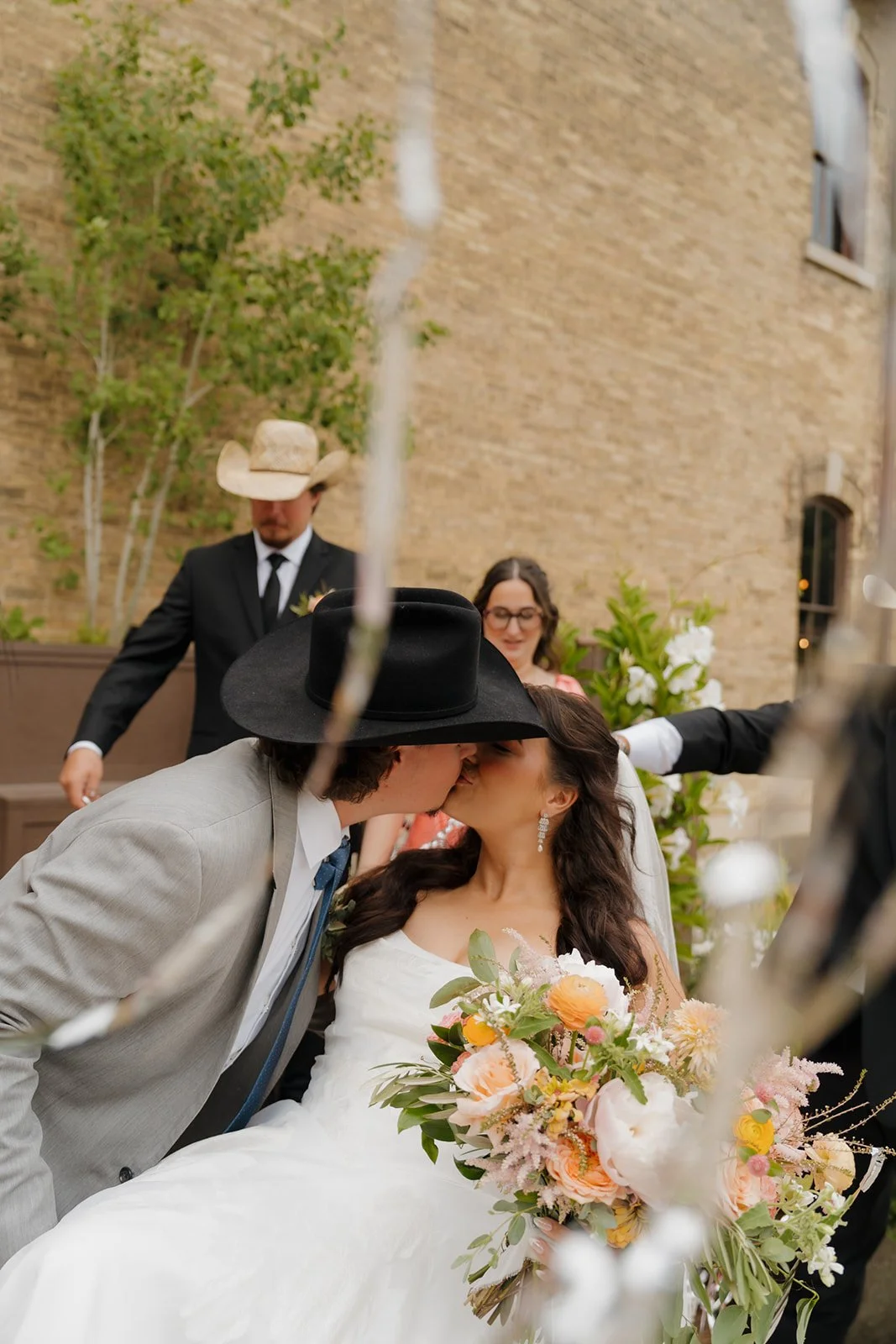 Celebration of bride and groom with the wedding party outside of The Lageret with streamers