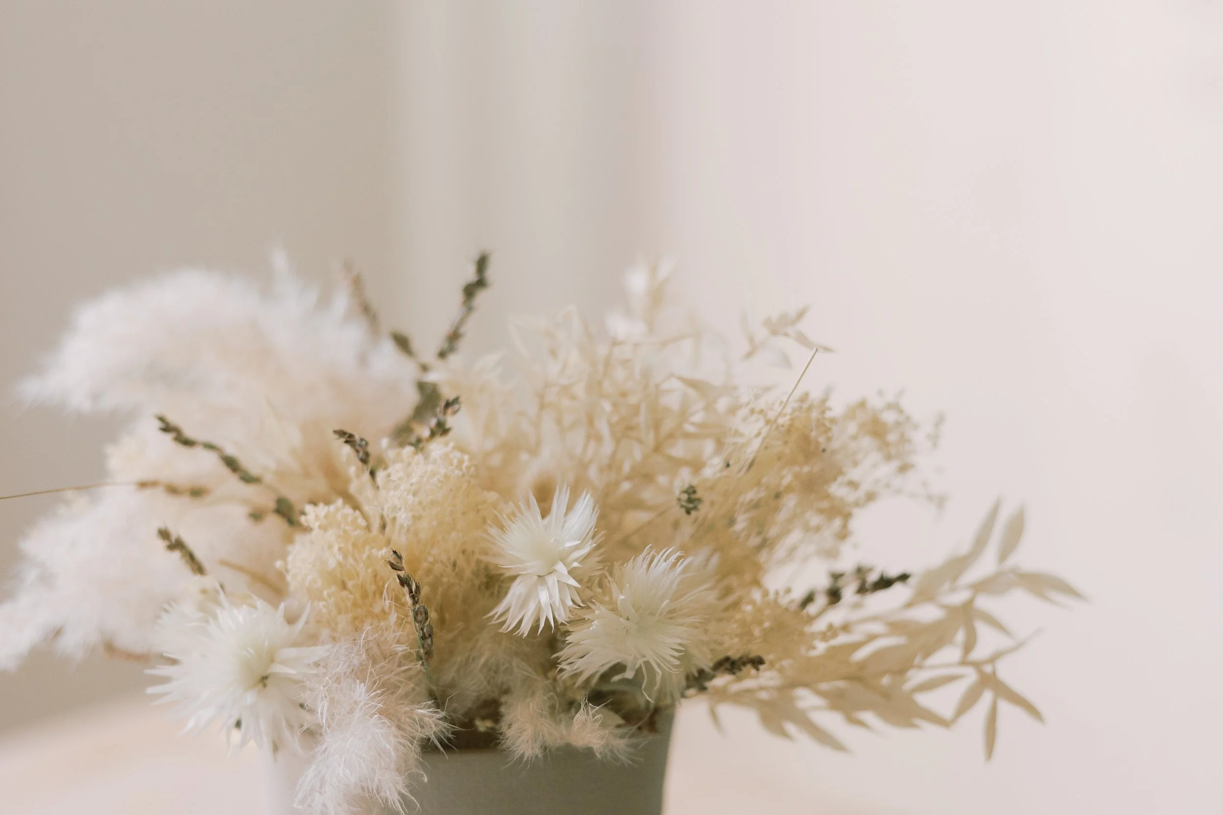 Cream-colored dried flower arrangement in a vase