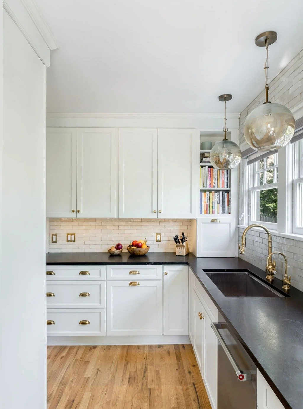 We recently completed this kitchen remodel in a historic Ann Arbor home, blending timeless character with thoughtful updates. Featuring handmade zellige tile backsplash, granite countertops inspired by classic soapstone, and unlacquered brass fixture