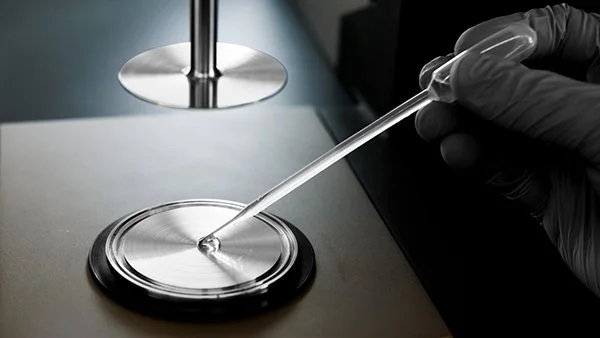 A Pasteur pipette in a lab setting.