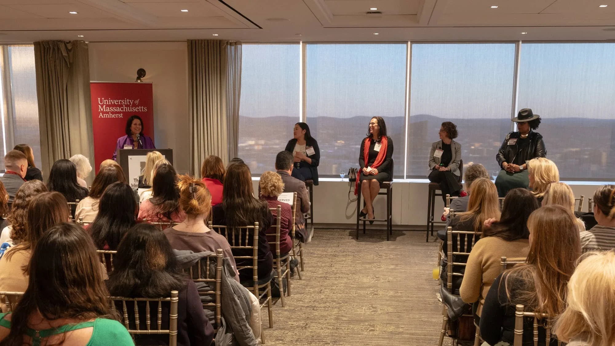 Audience listening to several panelists at Women for UMass' Spring Celebration