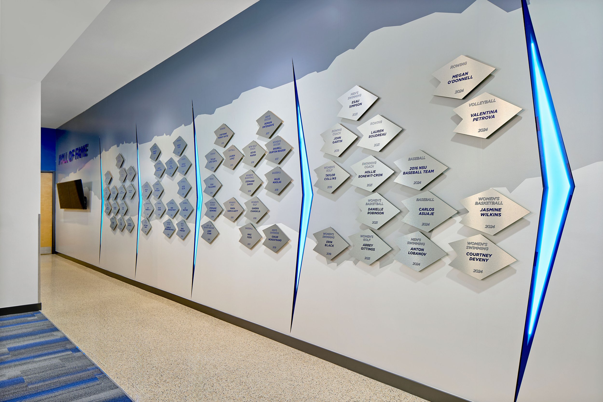 Athletic clubroom hall of fame environmental graphic installation and design at Rick Case Arena, Nova Southeastern University, showcasing S3 Design’s architecture and interior design for collegiate athletic facilities.