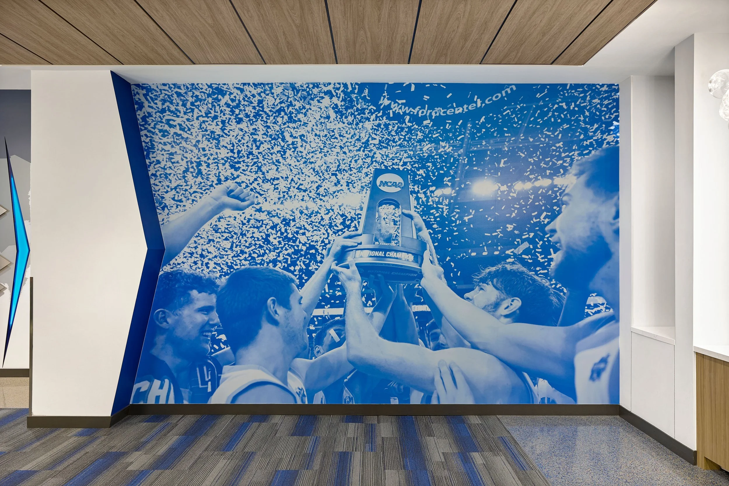 Athletic clubroom large-scale graphic at Rick Case Arena, Nova Southeastern University, showcasing S3 Design’s architecture and interior design for collegiate athletic facilities.