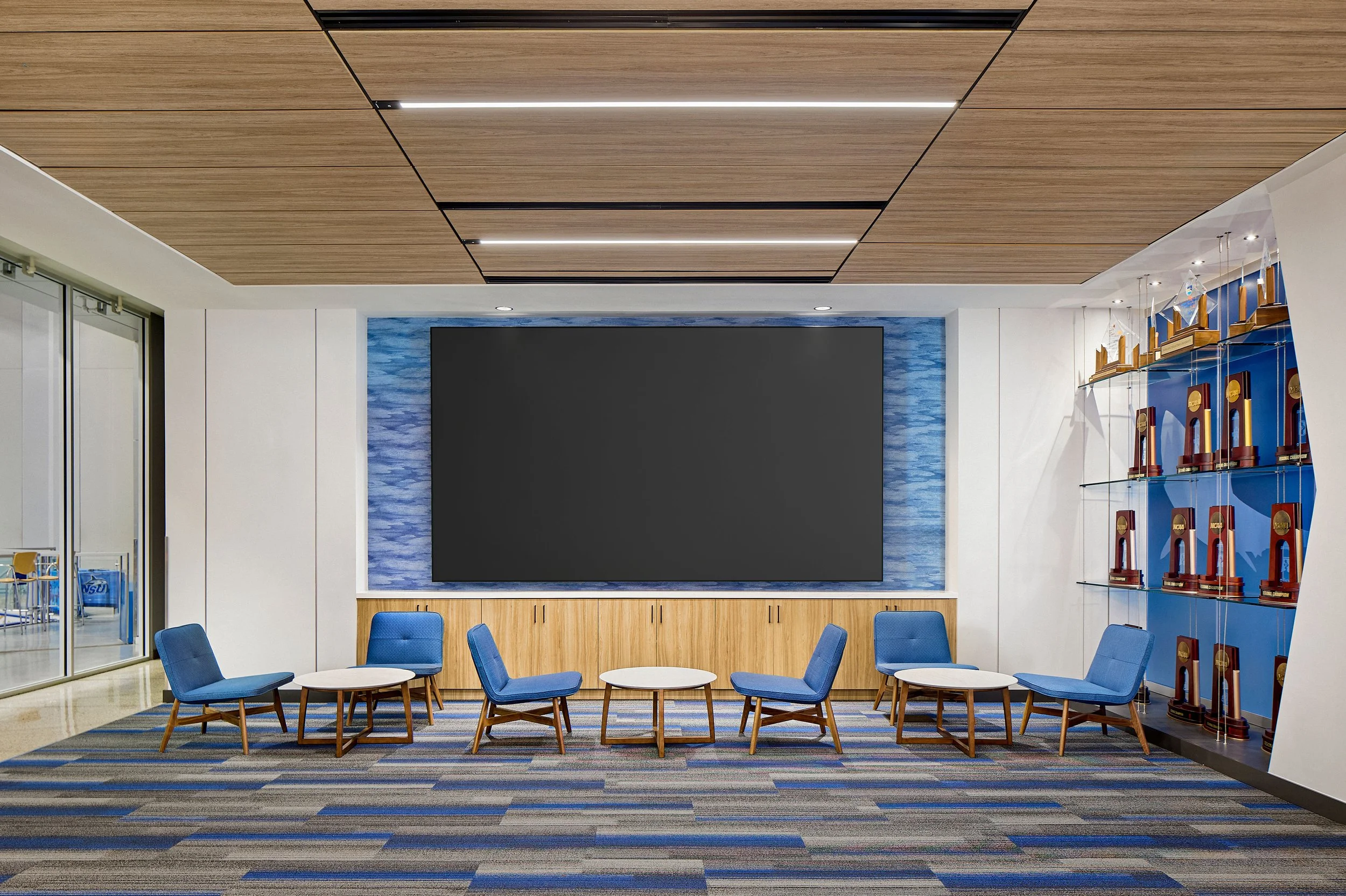 Athletic clubroom lounge seating at Rick Case Arena, Nova Southeastern University, showcasing S3 Design’s architecture and interior design for collegiate athletic facilities.