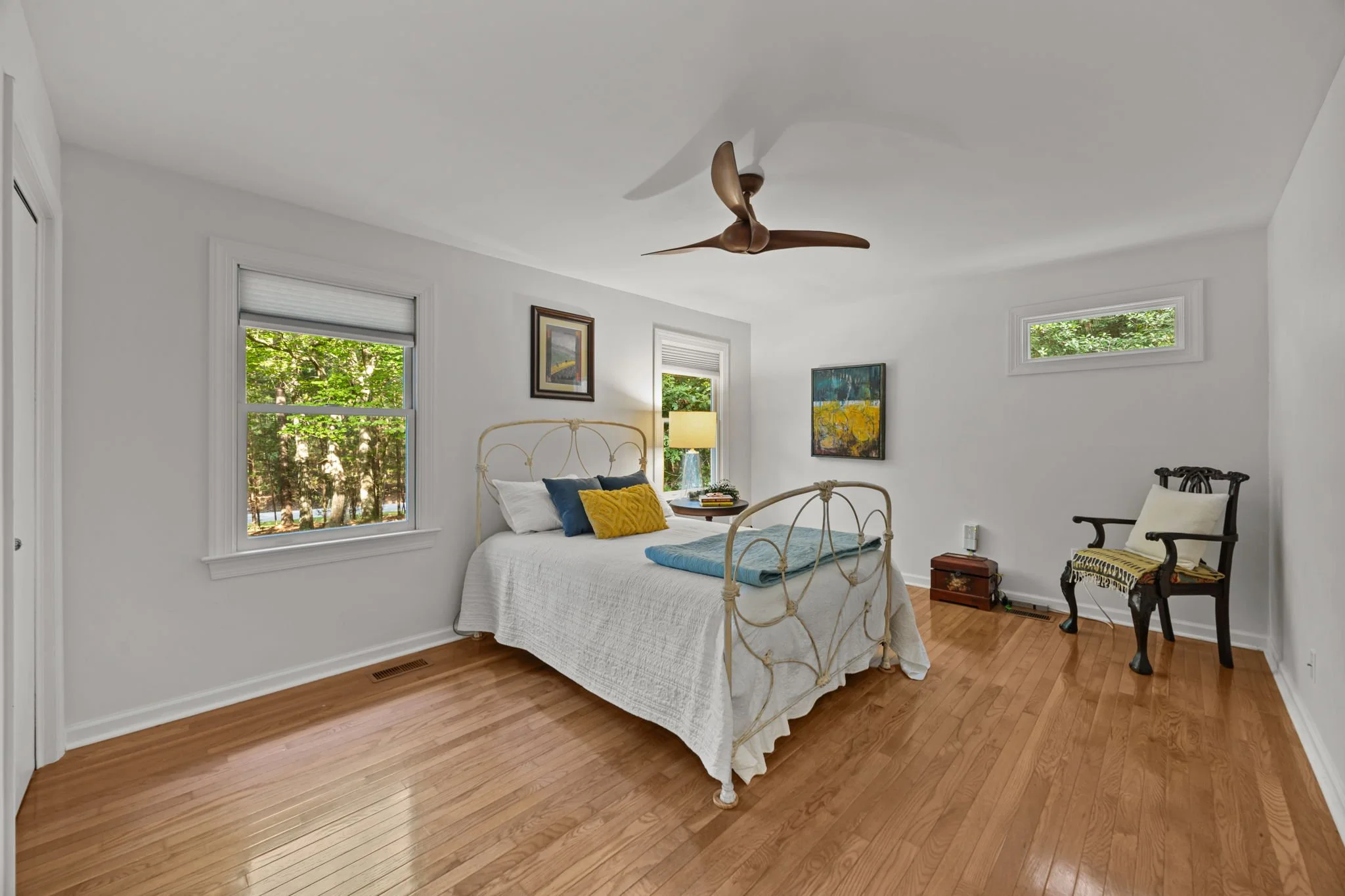 main bed with modern ceiling fan