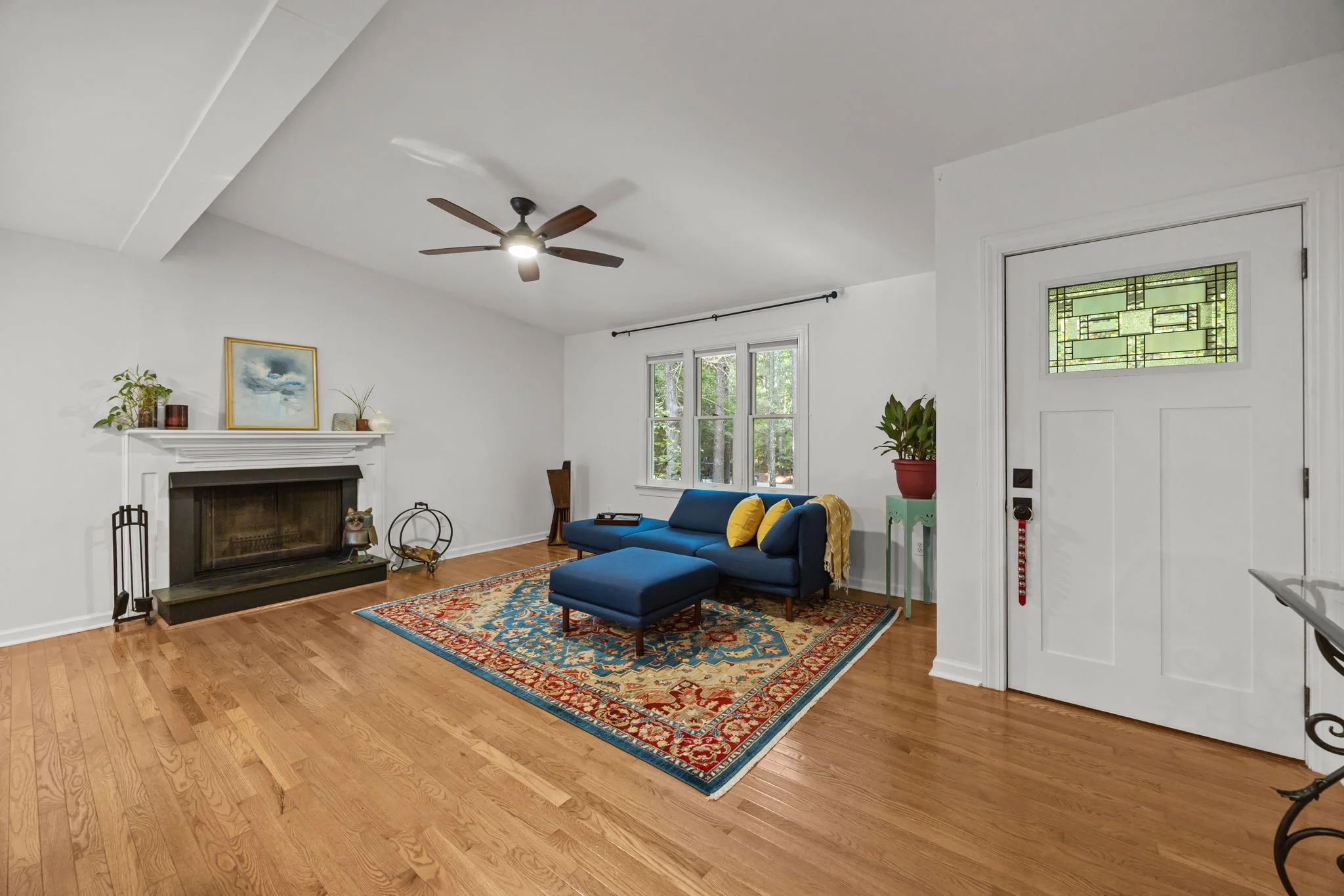 open concept living room with wood burning fireplace