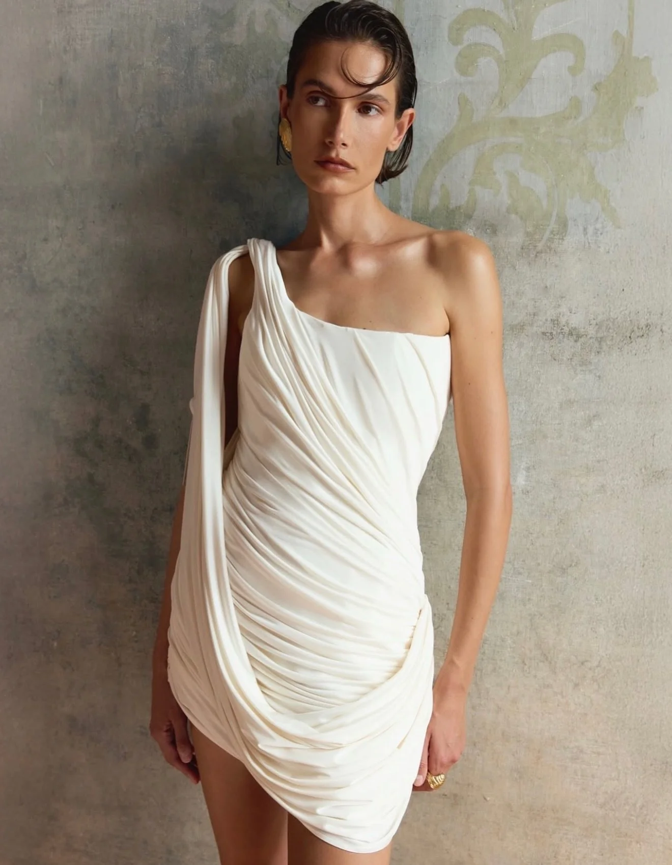BALYKINA IN STORE NOW &mdash;  The Kiara dress is like a light breeze on the skin. Made in Greek style with soft draperies that envelop the silhouette, the asymmetrical shoulder line reveals the collarbone. The lightweight fabric moves with you &mdas