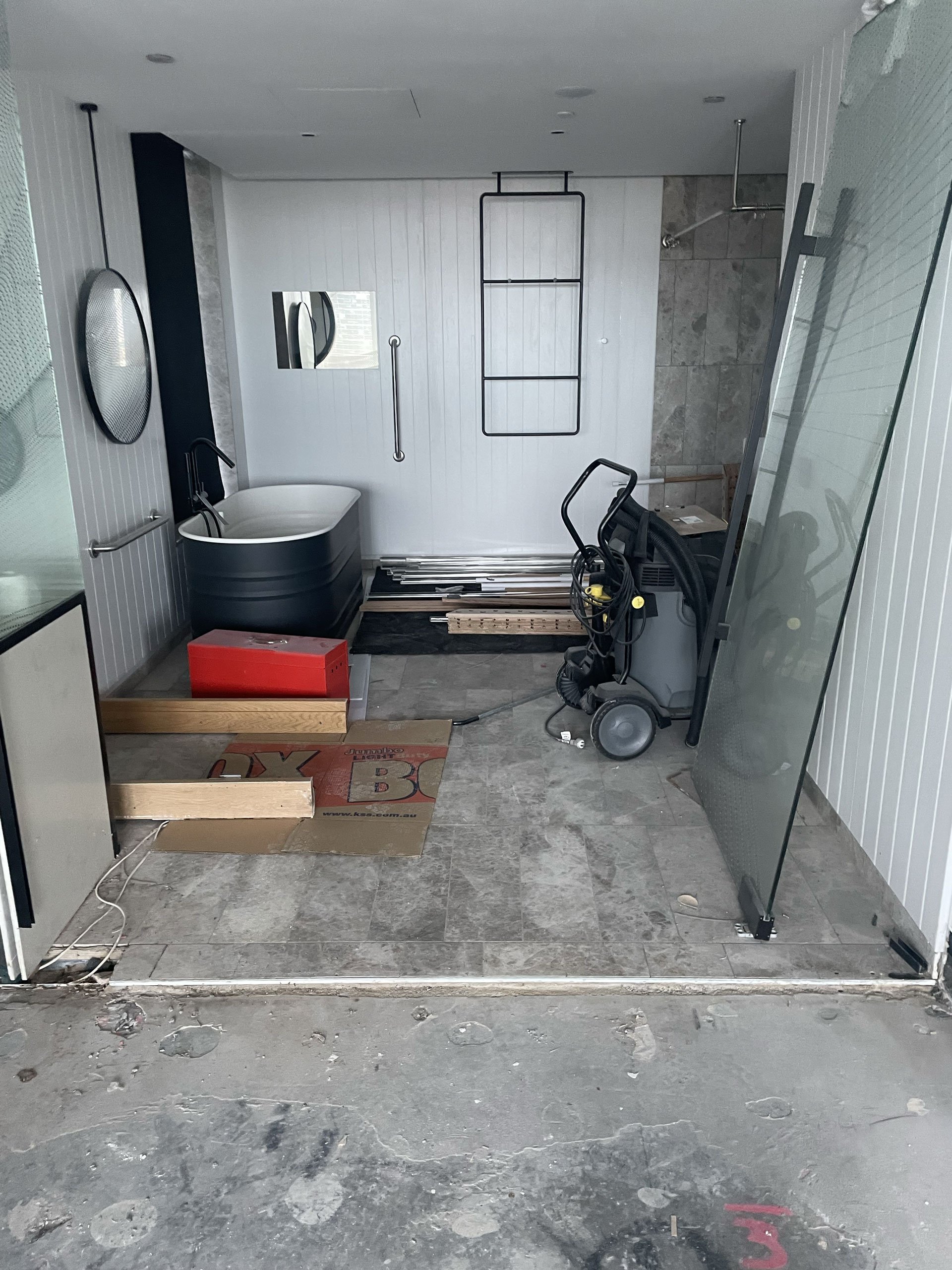 The bathroom undergoing maintenance from a leak which destroyed main areas of room 1201.