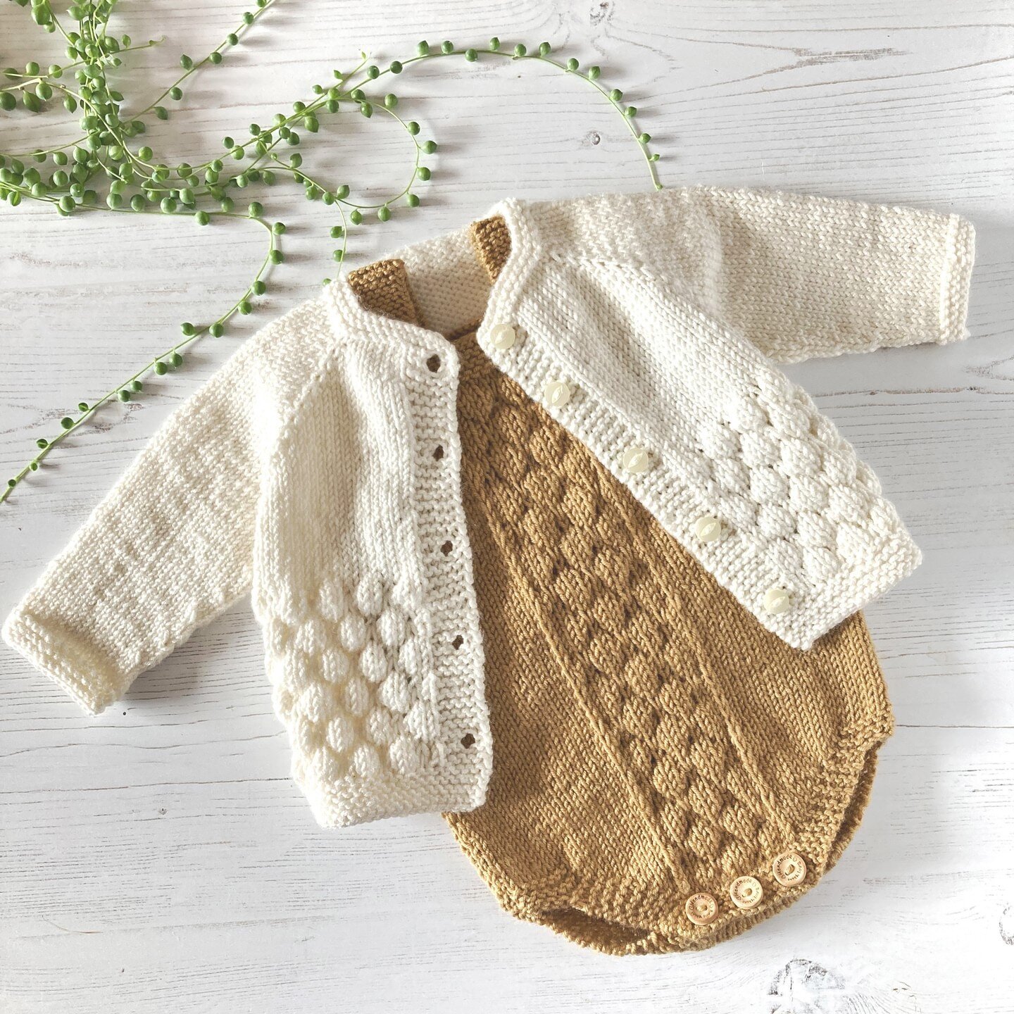 Bubble Stitch cardigan and romper knitting pattern bundle. The cardigan is knit top down, the romper is knit flat in 2 pieces and seamed.⁣
These have been knit in Rico Essentials Merino DK shades Camel for the romper and Natural for the cardigan. It'
