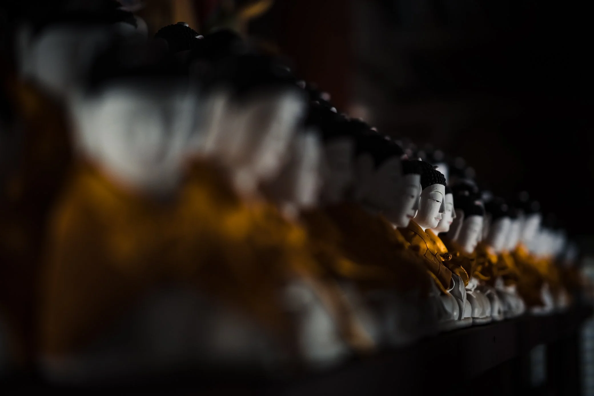 White buddhas inside the wooden pagoda at Beopjusa Temple