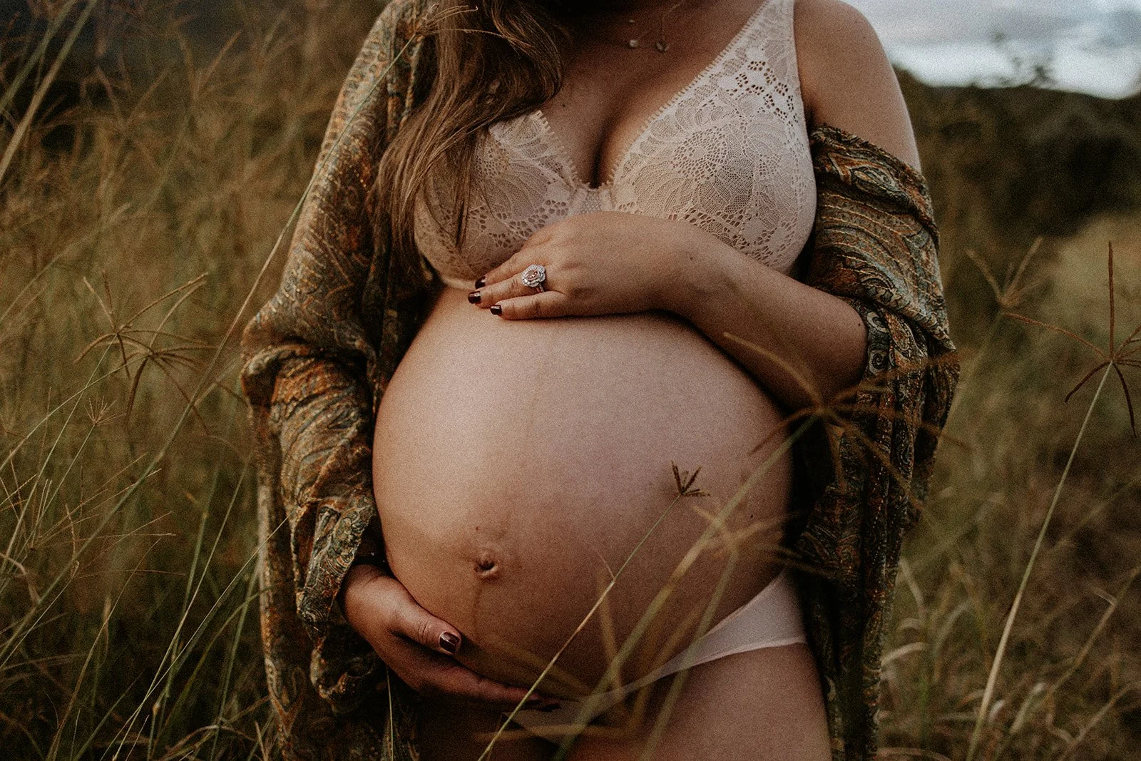 A Brisbane pregnant mother is photographed in a field.