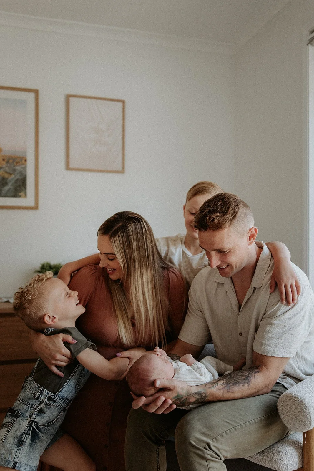 A family with their newborn baby is photographed in their Samford home. The image is of a relaxed lifestyle nature and shows beautiful colours and expressions of love.
