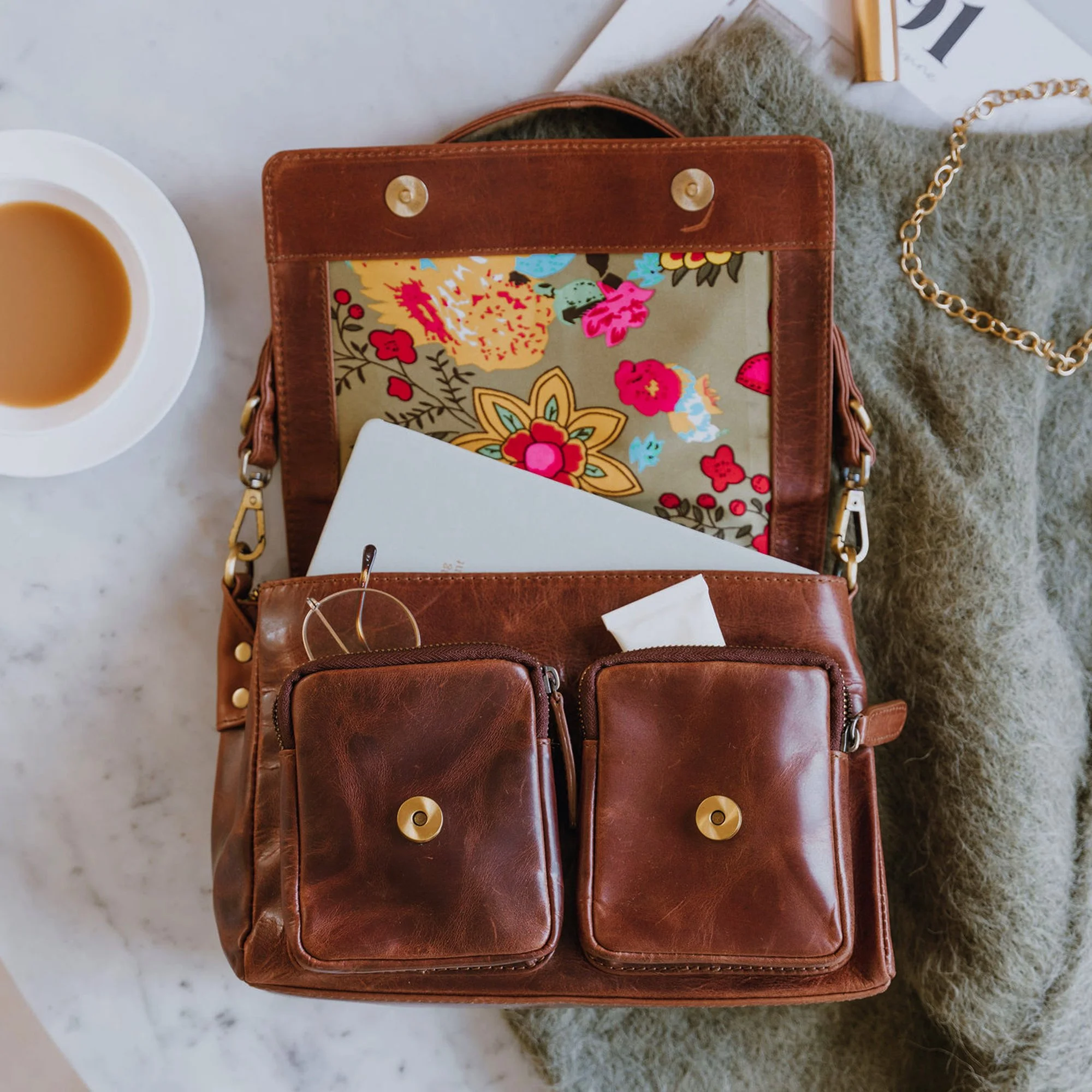 Brown leather shoulder bag with pockets led on a jumper 