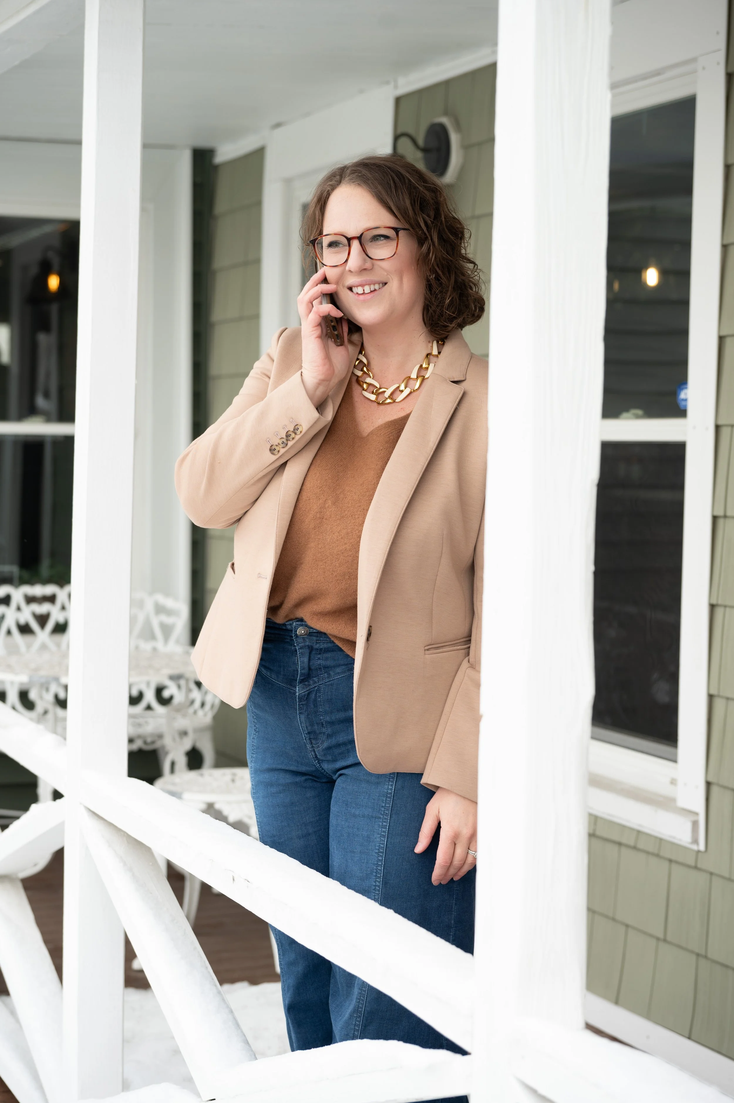 Female Realtor on the phone on a NH porch