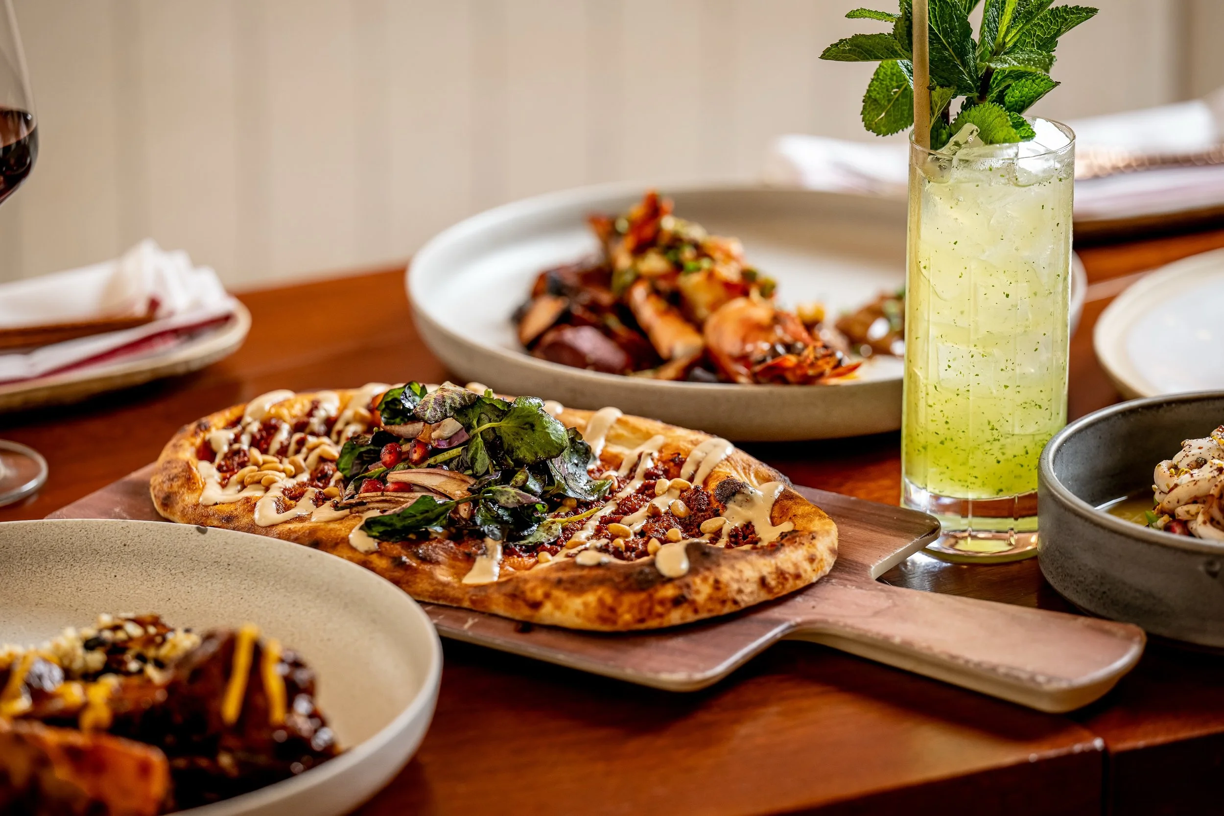 LAHMAJOUN 
Signature oven baked Frena bread with minced lamb, tahini, red watercress, and pomegranate

#frena #eatnyc #midtownbites #hellskitchennyc #eatstagram