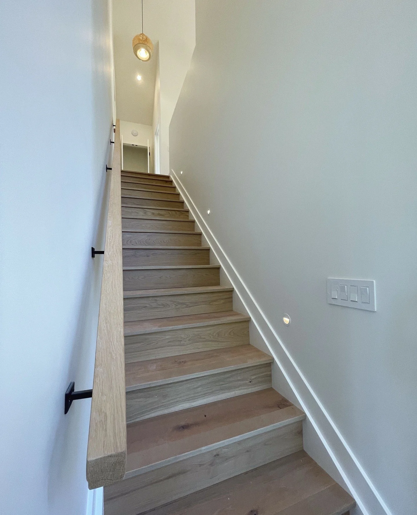 Every step makes a statement. Custom wood staircase with built-in ambient lighting blends craftsmanship and ambiance, turning a simple transition into a stunning design feature. ✨ #MarquiseConstruction #ModernCottage #CustomDesign #StatementStairs
