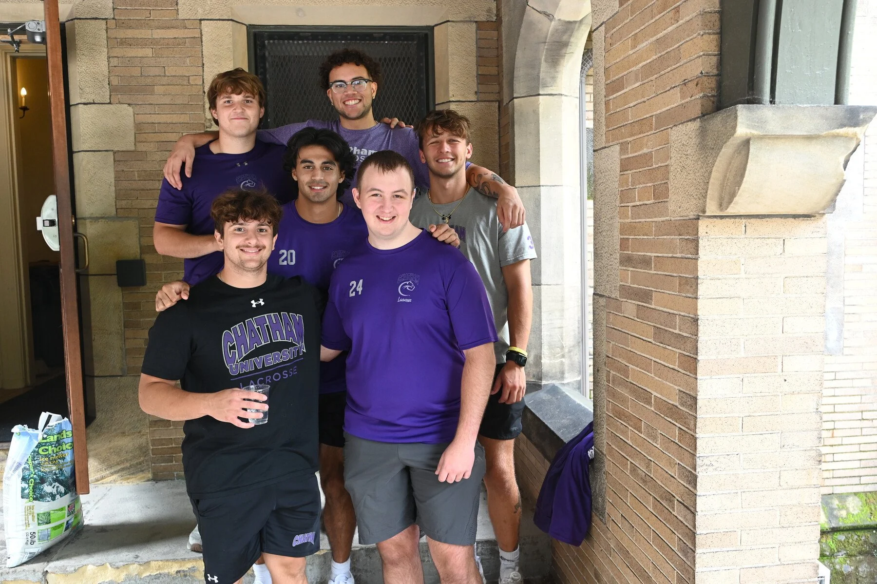 A group of Chatham University male athletes pose for a photo together on Move-In Day