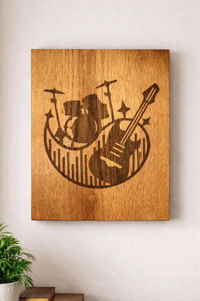 Laser engraved guitar and drum wood wall art hanging on a wall near a window in natural light