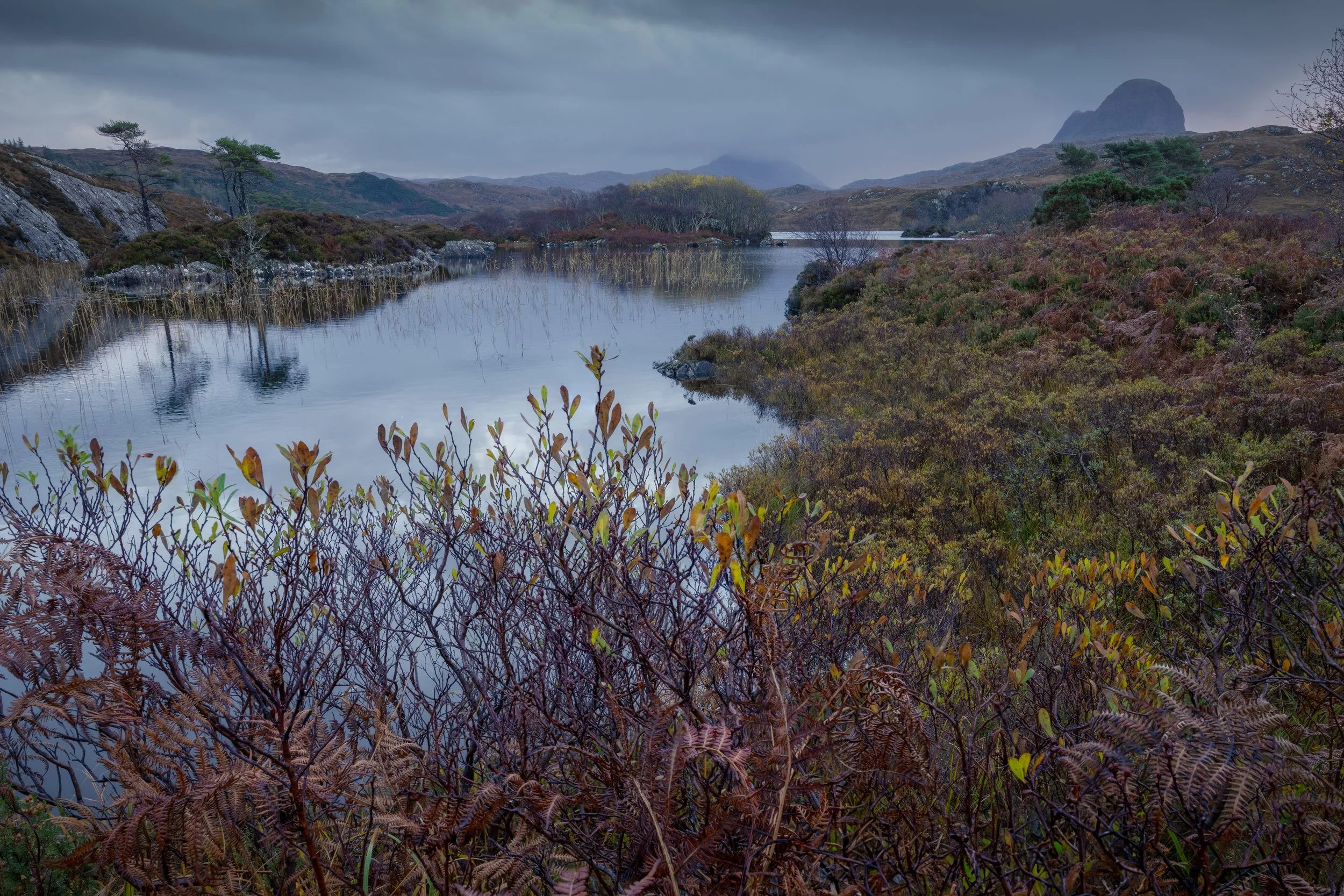 A landscape photograph of Canisp and Suilven at Loch Druim Suardalain in Assynt and Coigach in the Northwest Highlands of Scotland.