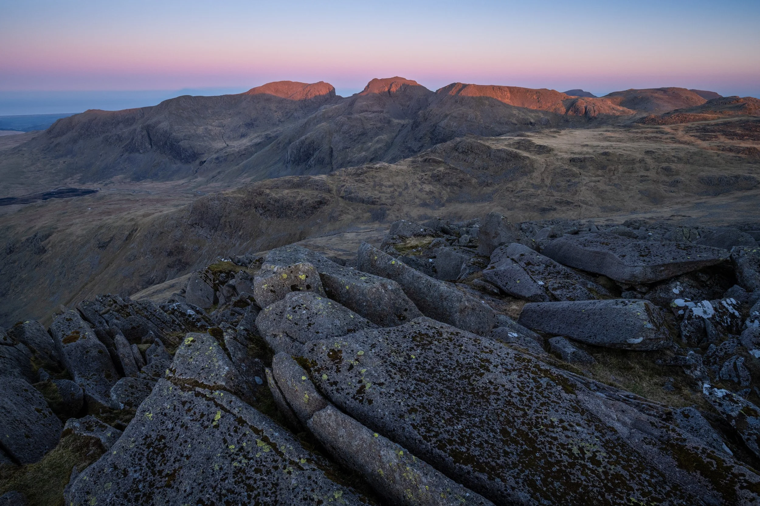 Scafell Pike and Scafell from Bowfell in the Lake District National Park at sunrise.