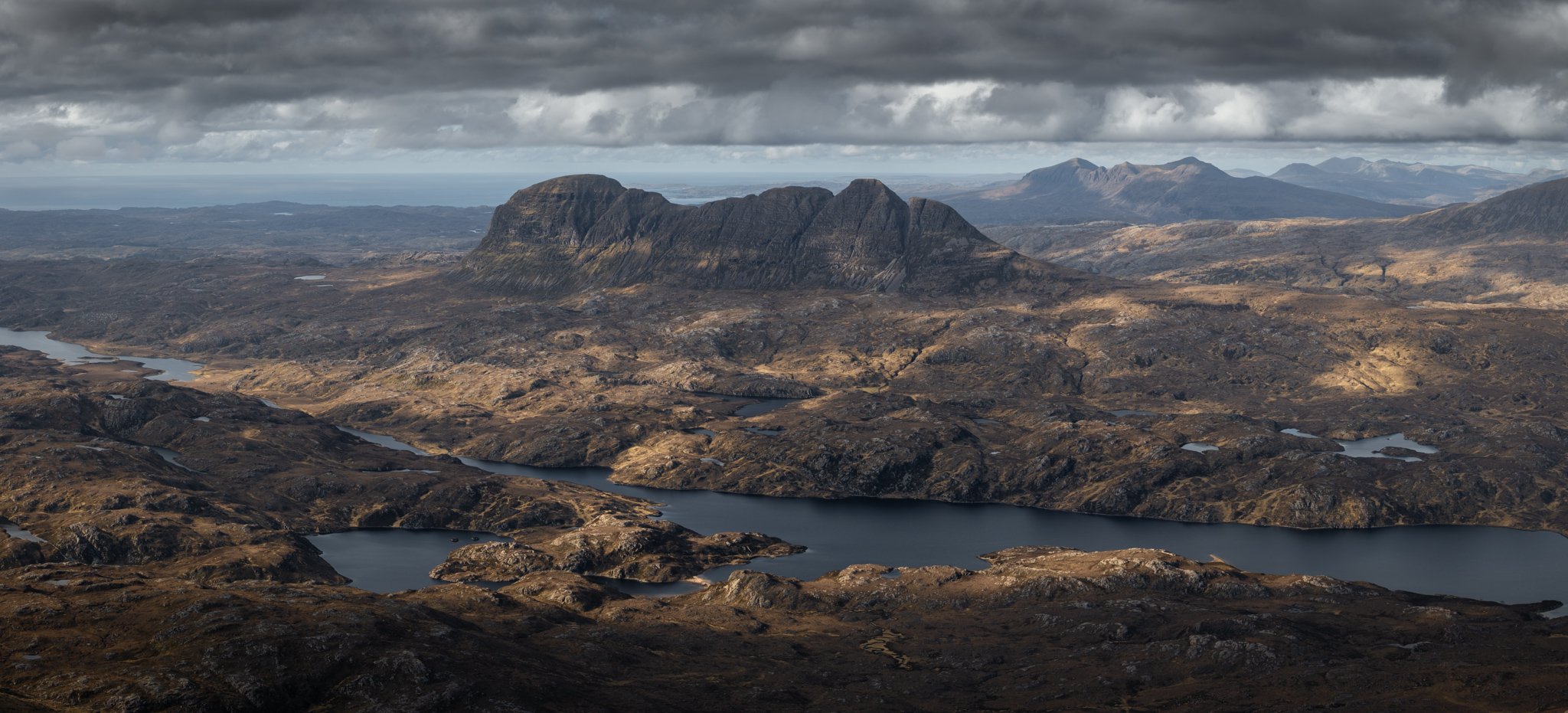 Panoramic landscape photography of Suilven from the summit of Cul Mòr in Assynt, Scotland.