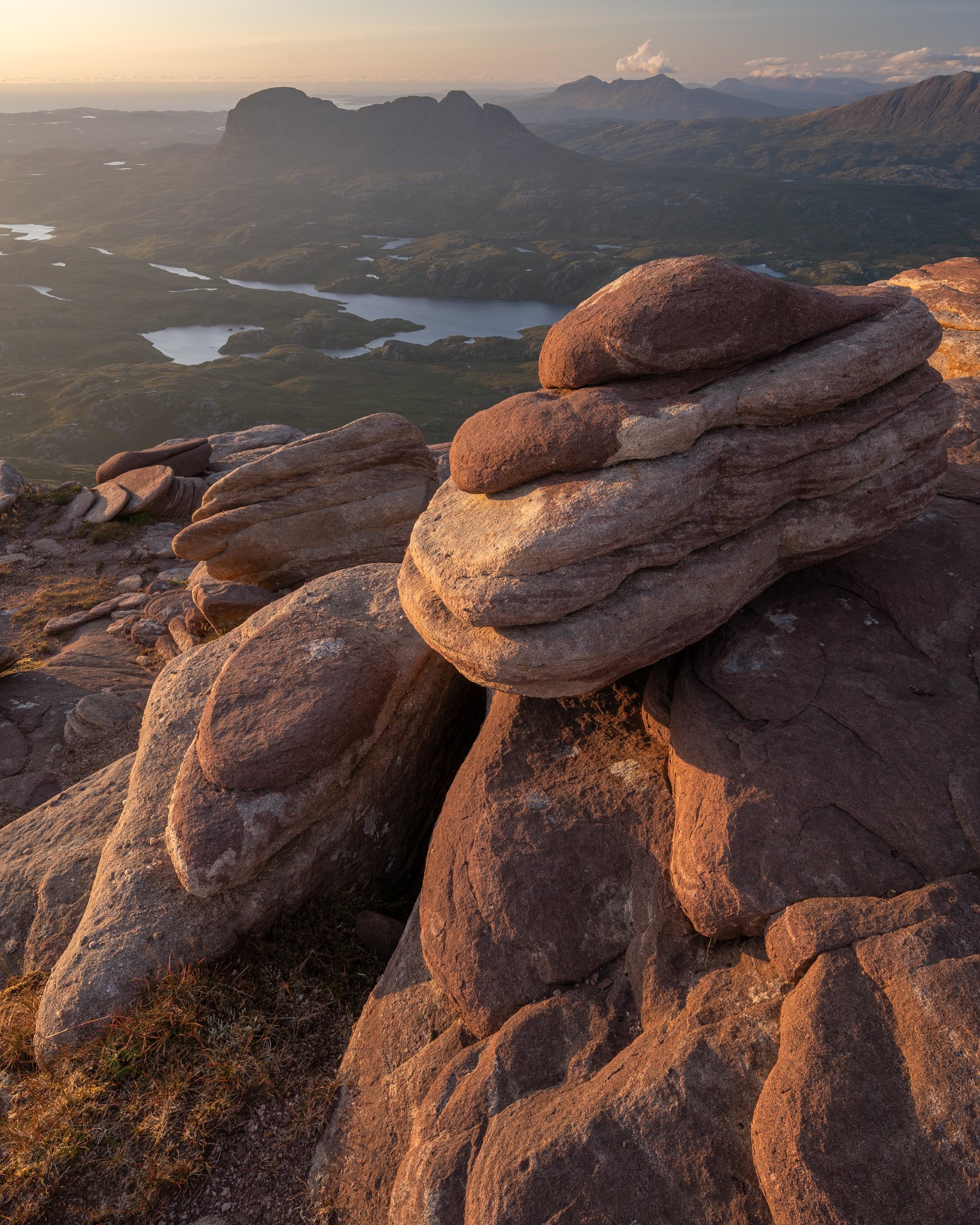 Landscape photography from the summit of Cul Mòr in Assynt, Scotland, at sunset with spectacular views north towards Suilven, Quinag and Canisp.