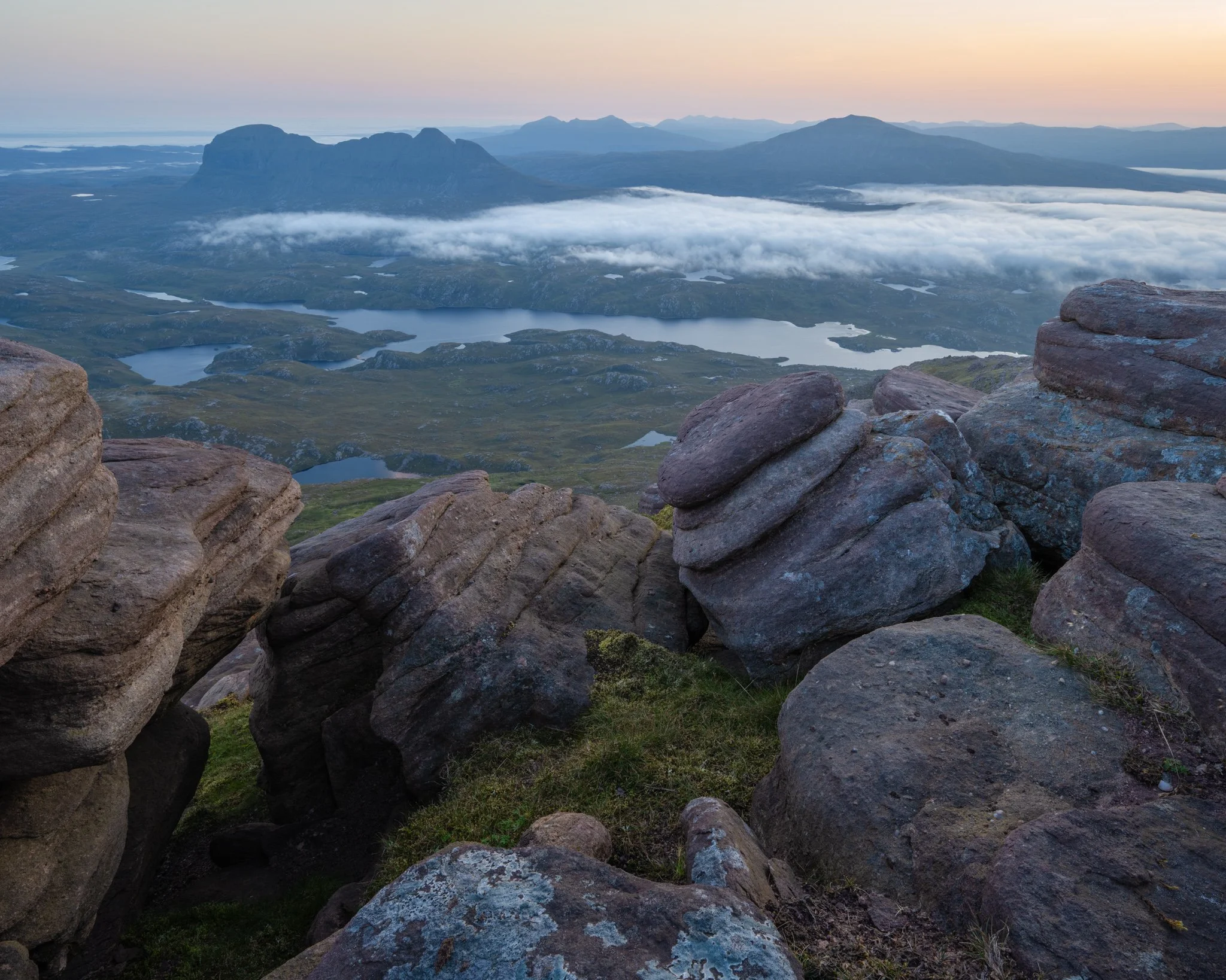 Landscape photography from the summit of Cul Mòr in Assynt, Scotland, at sunrise with spectacular views north towards Suilven, Quinag and Canisp.