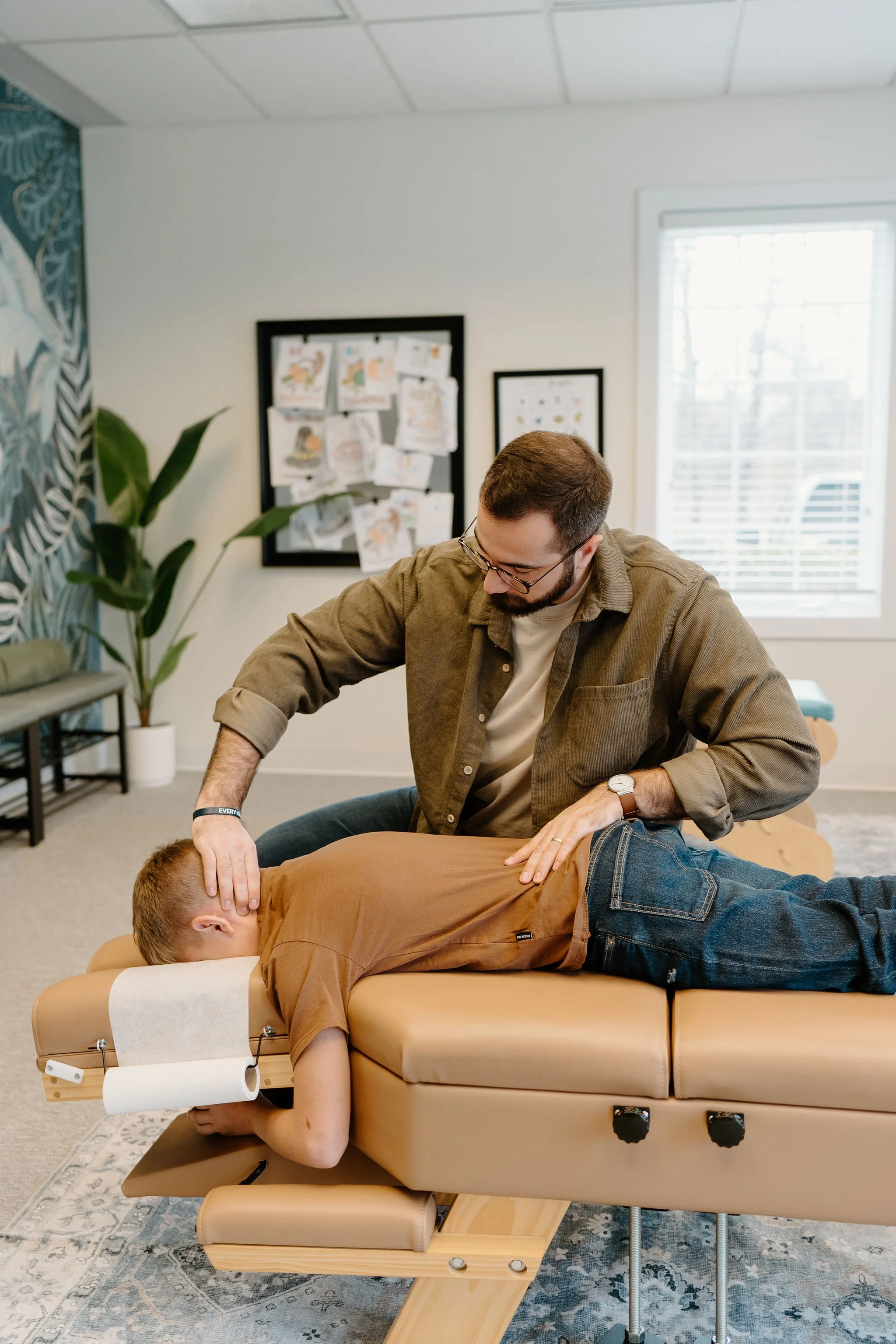 A teen receiving a chiropractic adjustment.