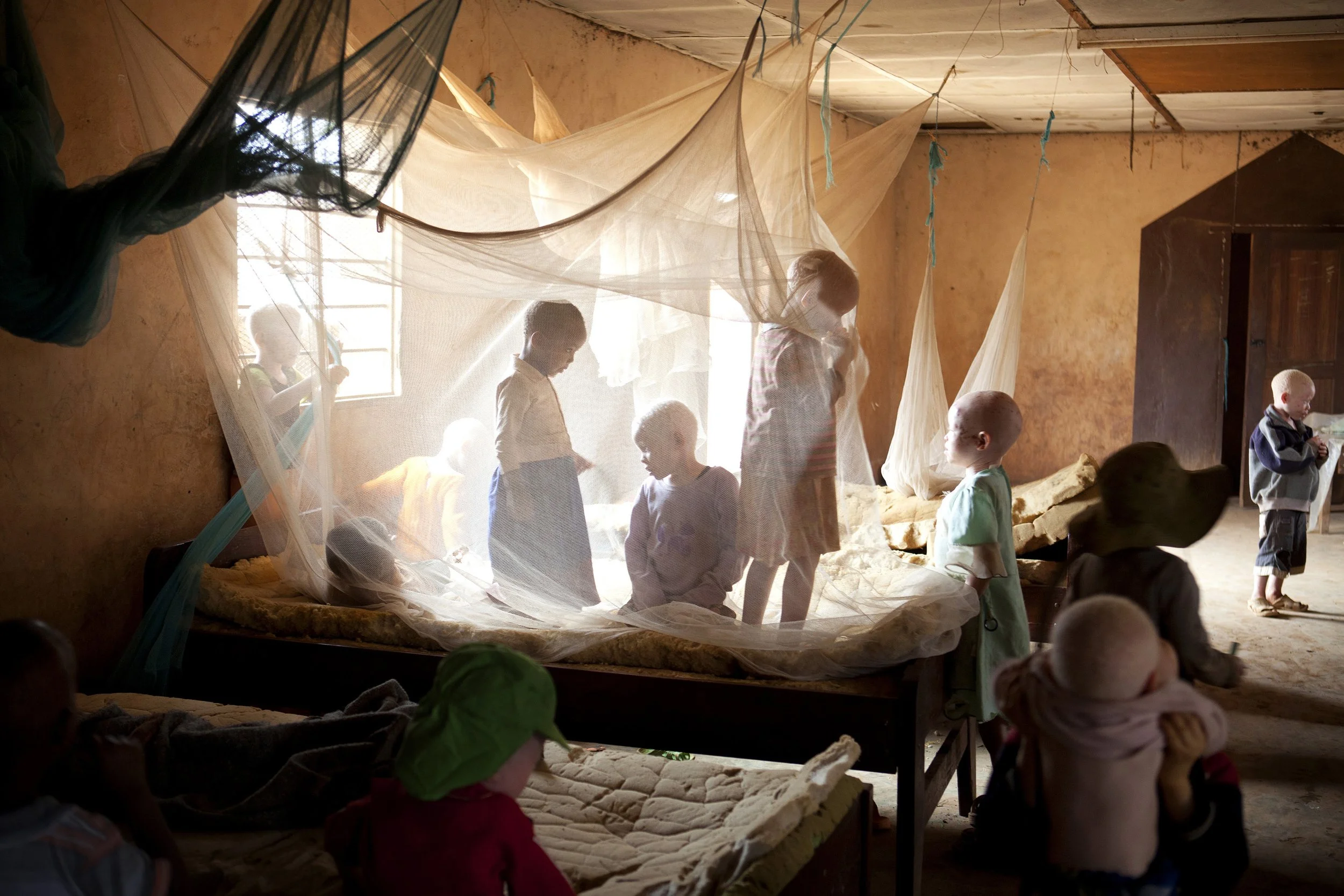 (photo by Jacquelyn Martin) Kabanga, Tanzania, Aug. 27, 2012: Children play inside the Kabanga Protectorate Center. People with albinism have been sent to live at the center for their own safety. In Tanzania, having albinism can be a death sentence.
