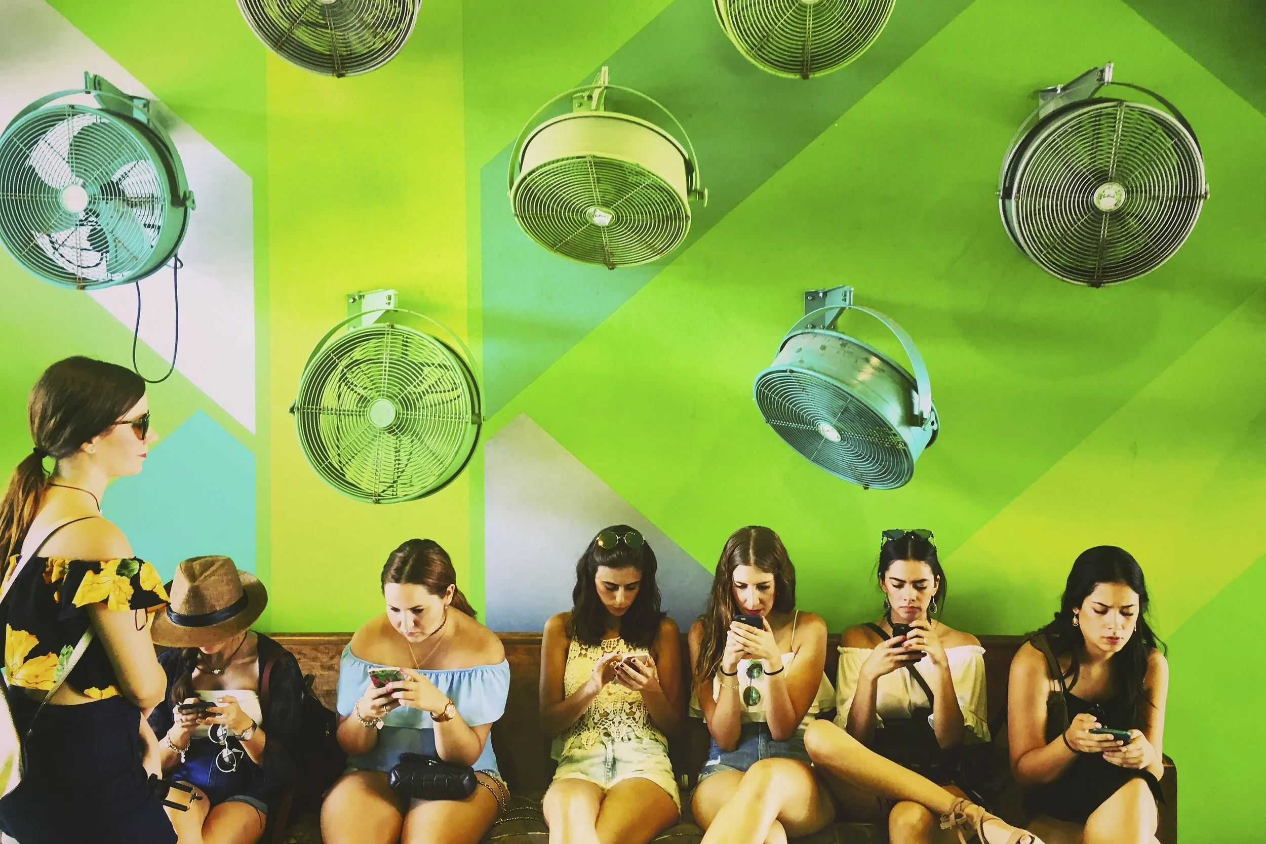 (photo by Deveney Williams) Miami, Fla., May 27, 2016: In a city built on art, we still reach for our phones for connection. Walking through Miami’s Wynwood neighborhood, I noticed the people glued to their screens instead of the artwork around them.