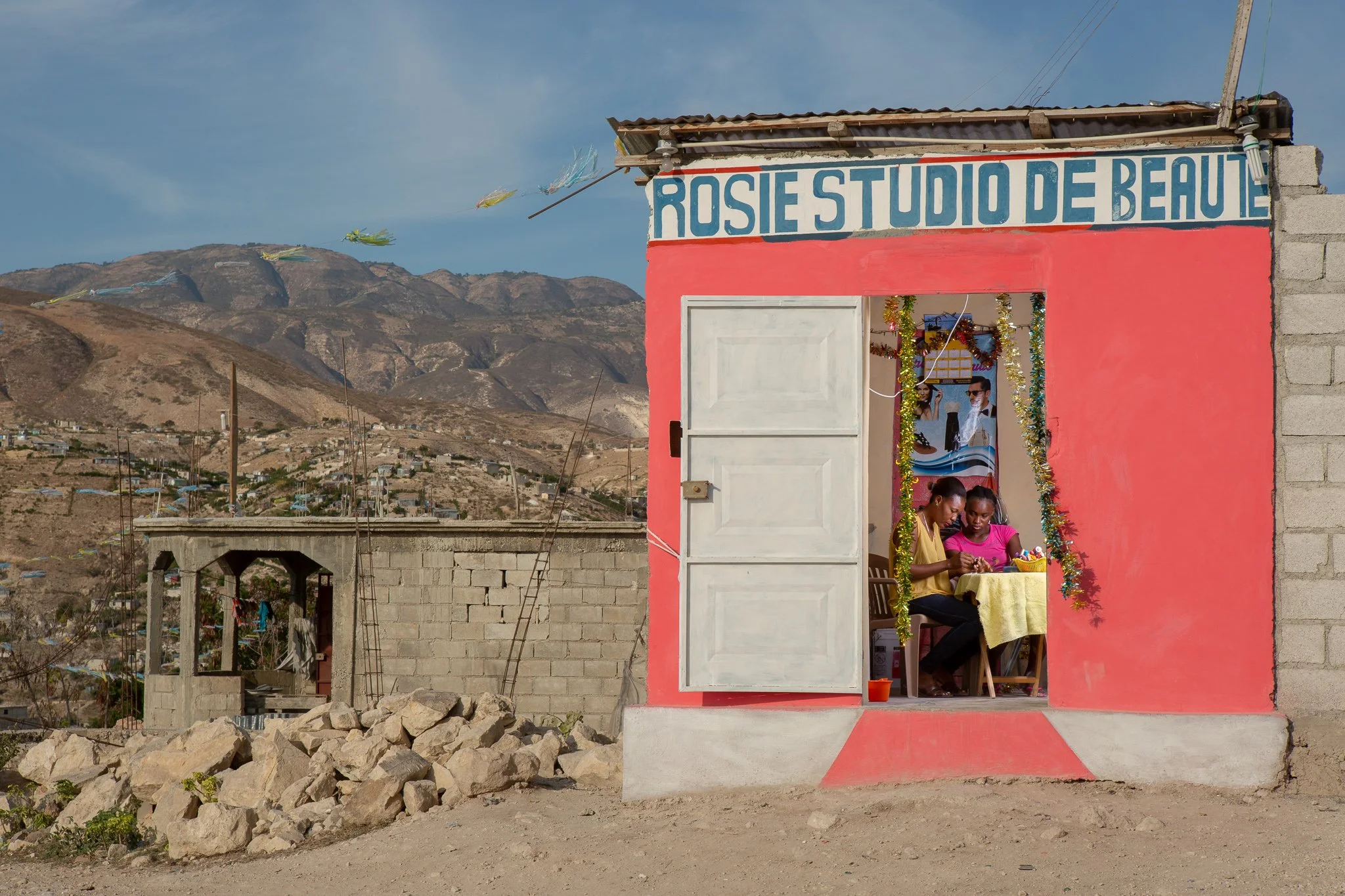 (photo by Allison Shelley) Canaan, Haiti, Jan. 9, 2019: "Rosie" Prospere, 35, gives a manicure to Dieuny Delizin, 19, at her salon. Prospere moved in 2015 to open her own shop. Four years later, she dreams of opening a regional chain of beauty salons