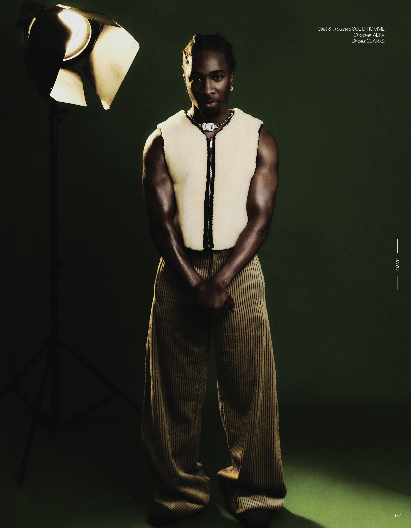 Notion magazine editorial portrait featuring Jayo in studio lighting wearing tailored look against green background photographed by Radhika Muthanna