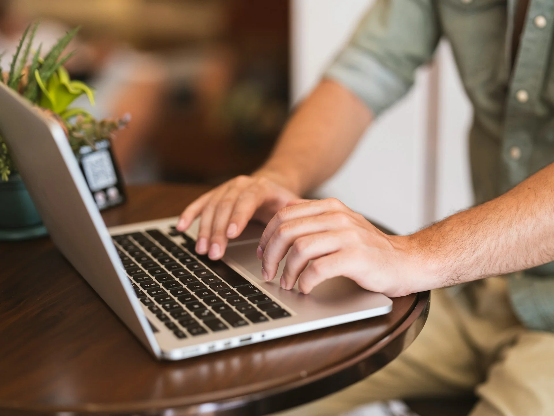 Business owner working on laptop at a café — Shift In Life consulting, Orange County