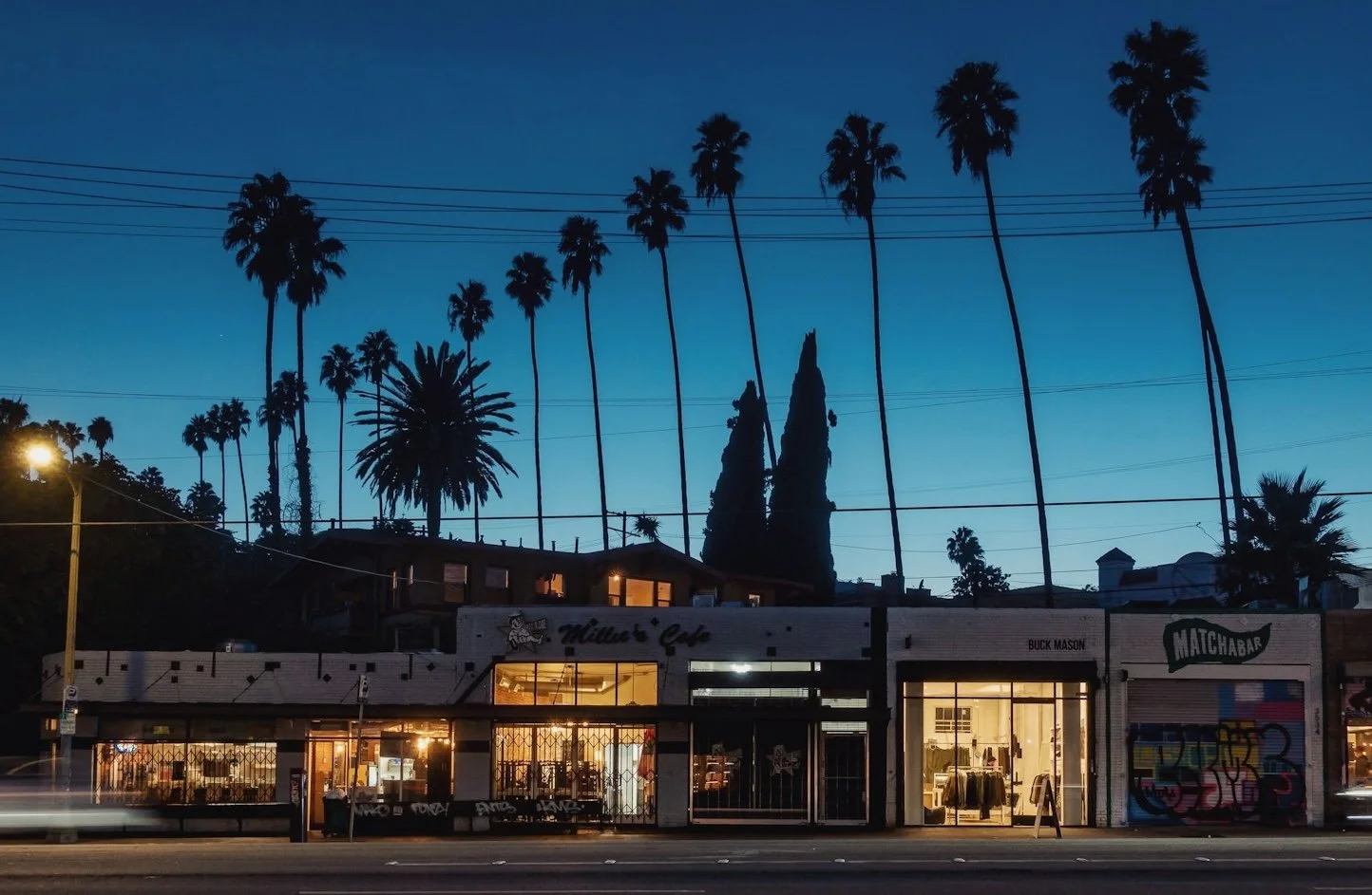 Several storefronts across a street with the blue hour behind them, shift in life consulting