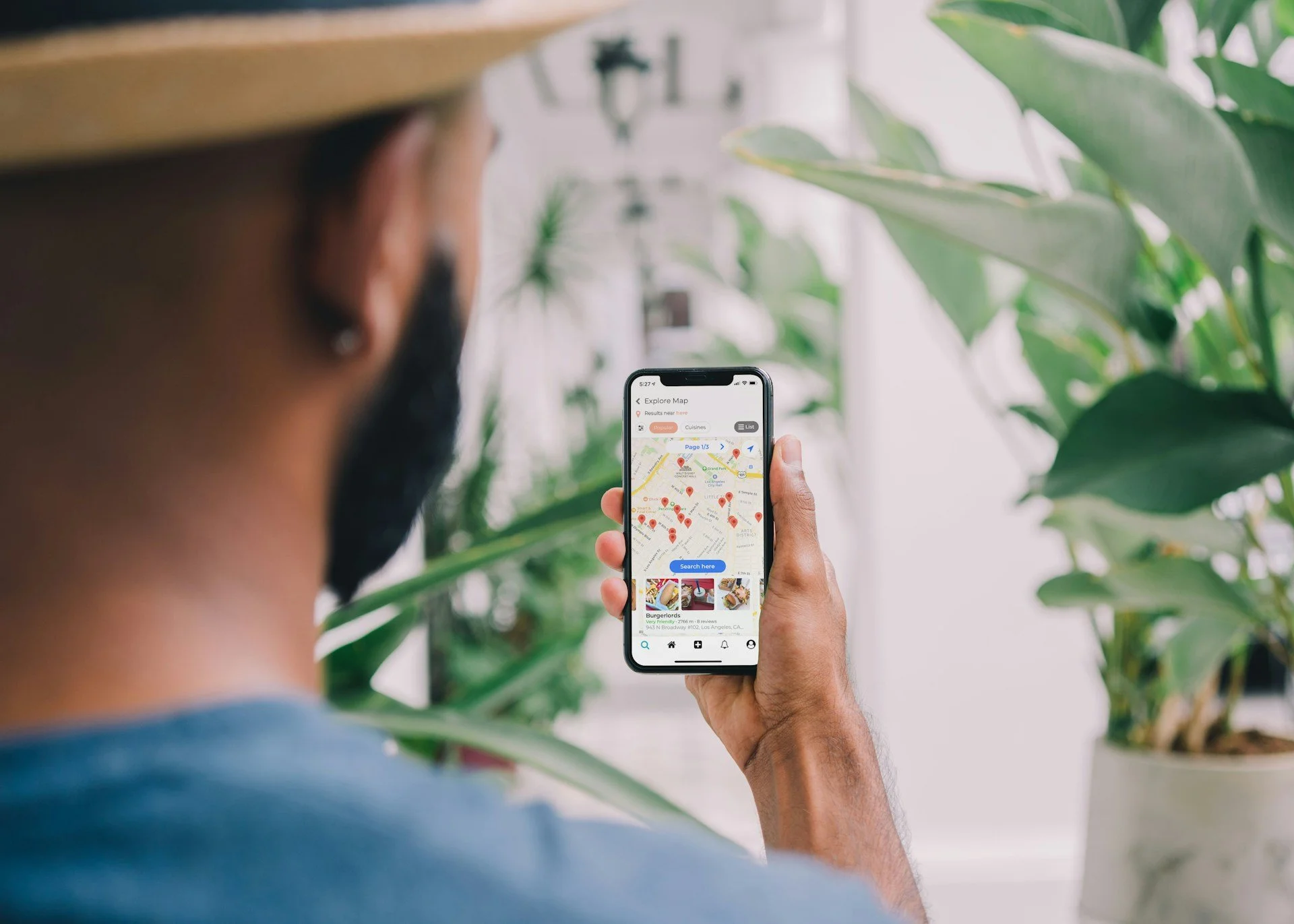 Young man looking for a business using his phone and Google Maps
