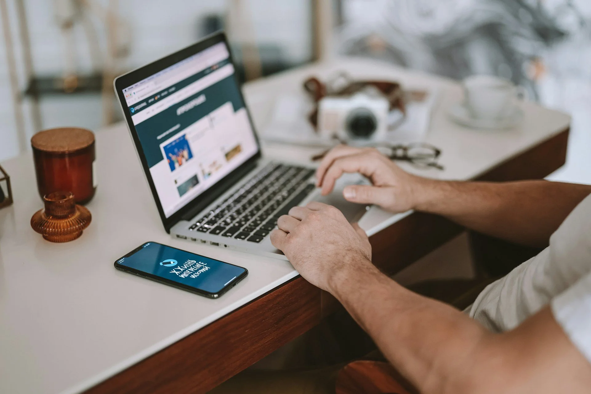 Person working on their laptop at their desk with complete ease