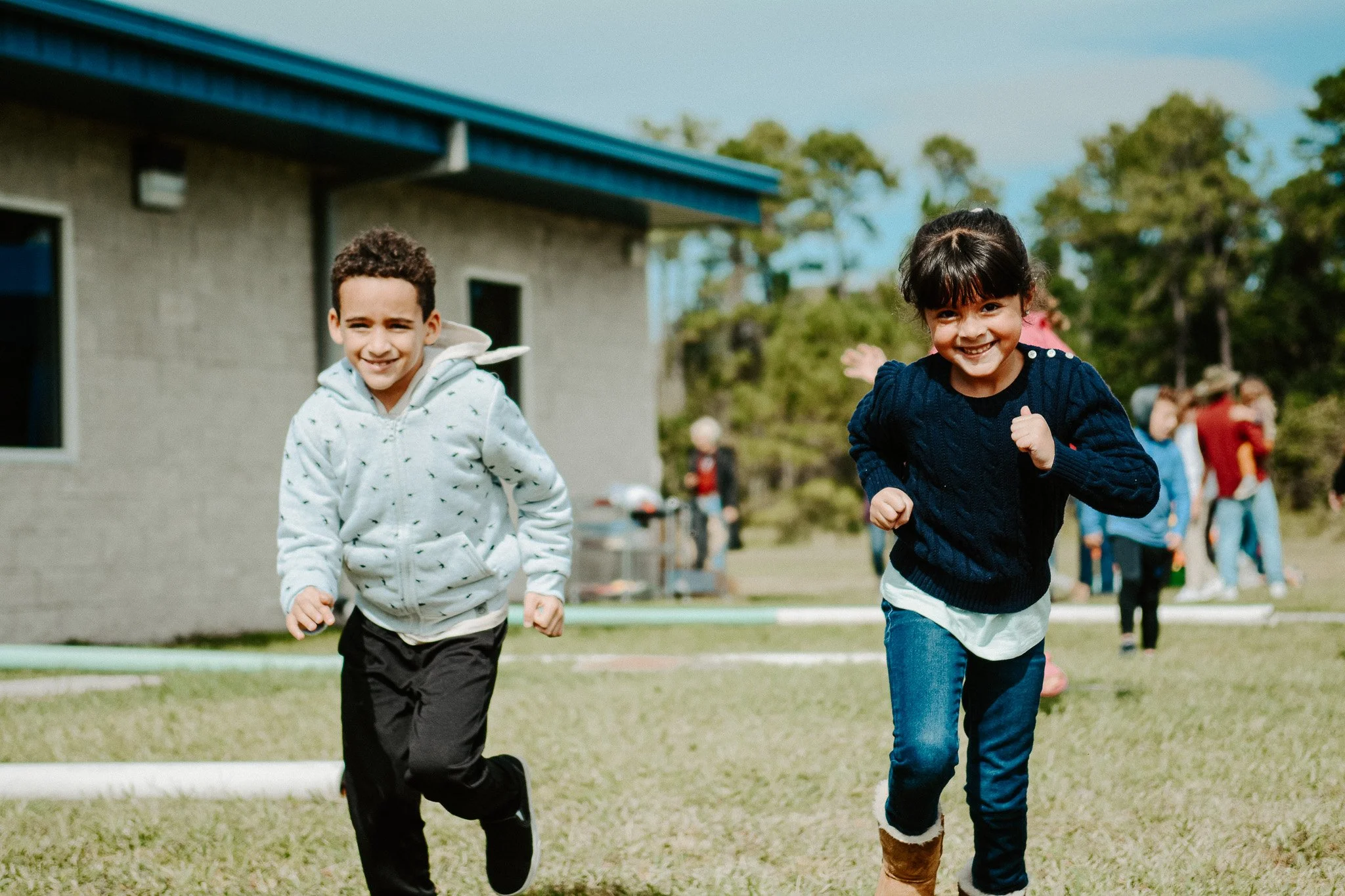 two children running in a field