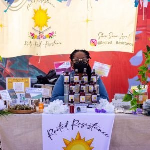 Rooted Resistance selling products at event (Copy)
