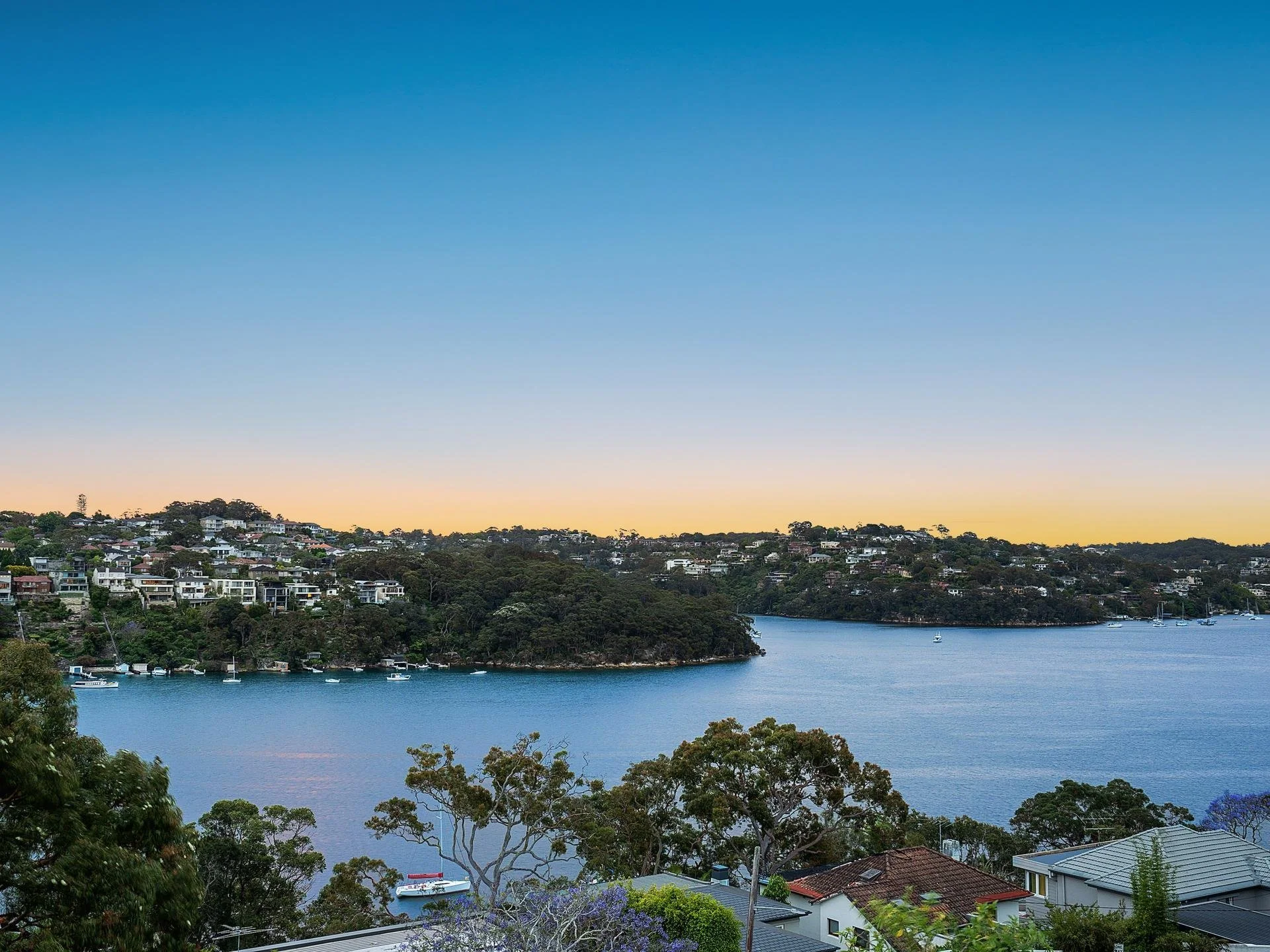 Twilight view over Middle Harbour from a Mosman property set for redevelopment