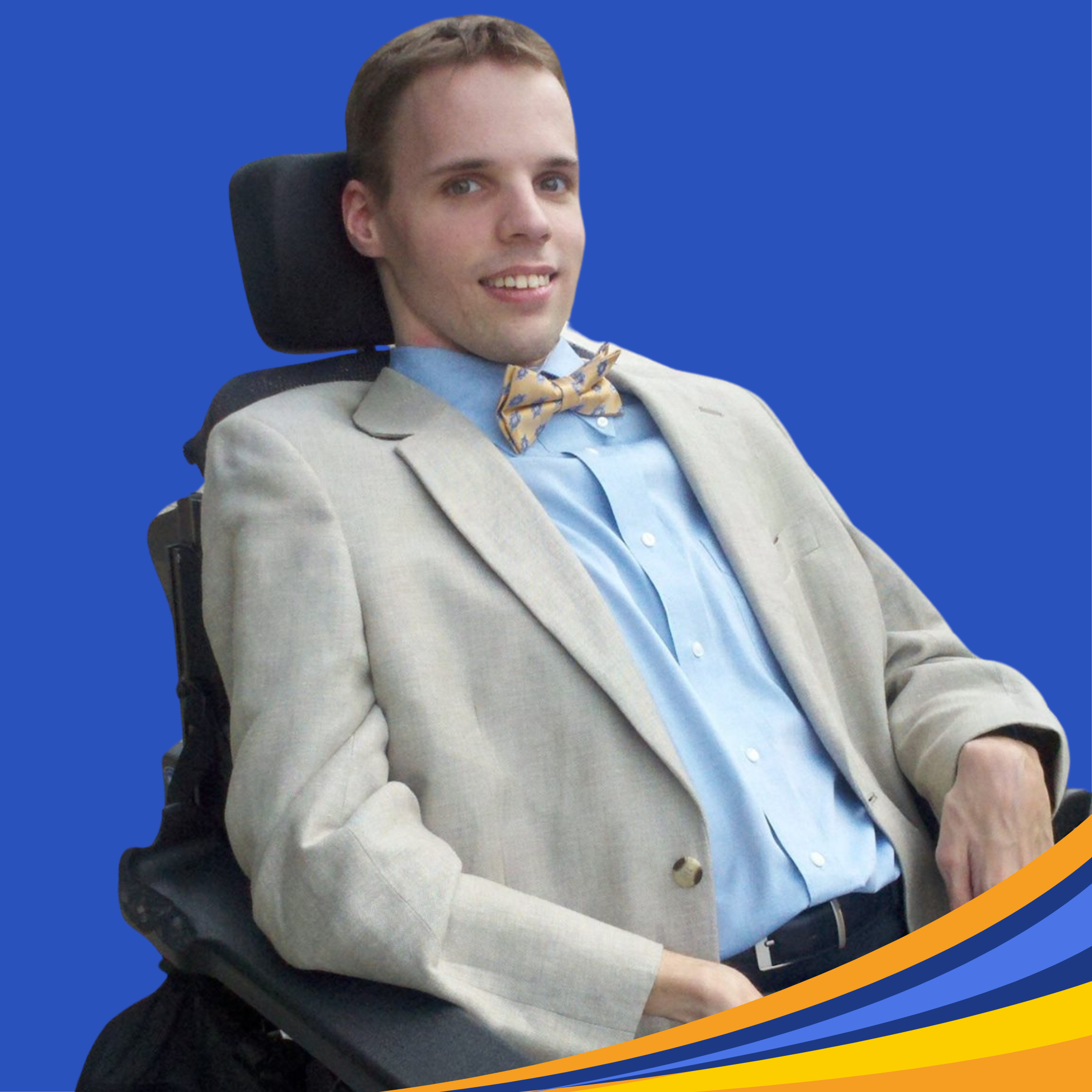 smiling man with blazer and bow tie with brown short hair sitting in wheelchair