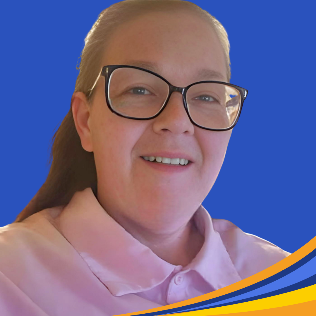 smiling woman with pink shirt and glasses