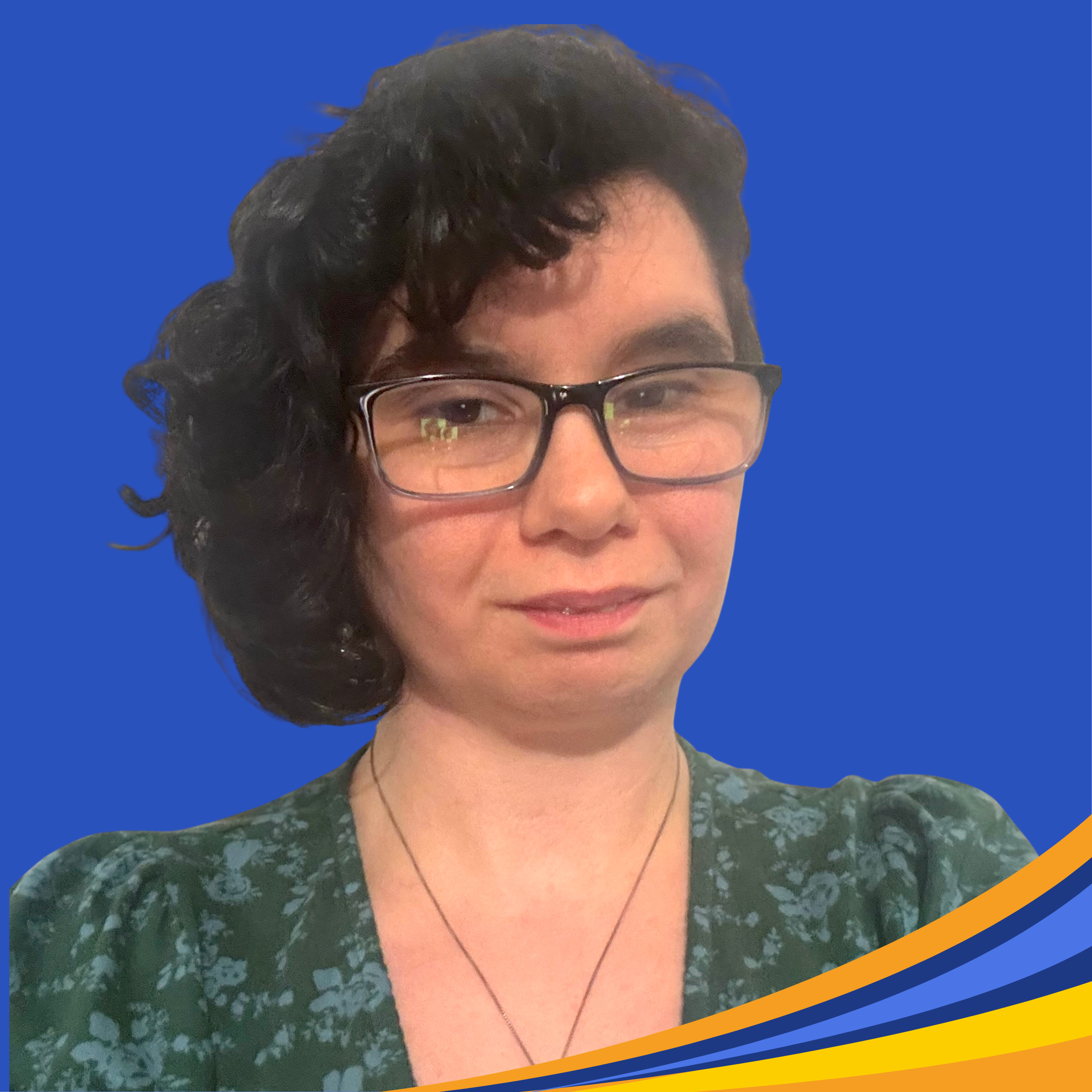 smiling woman with dark curly hair and glasses